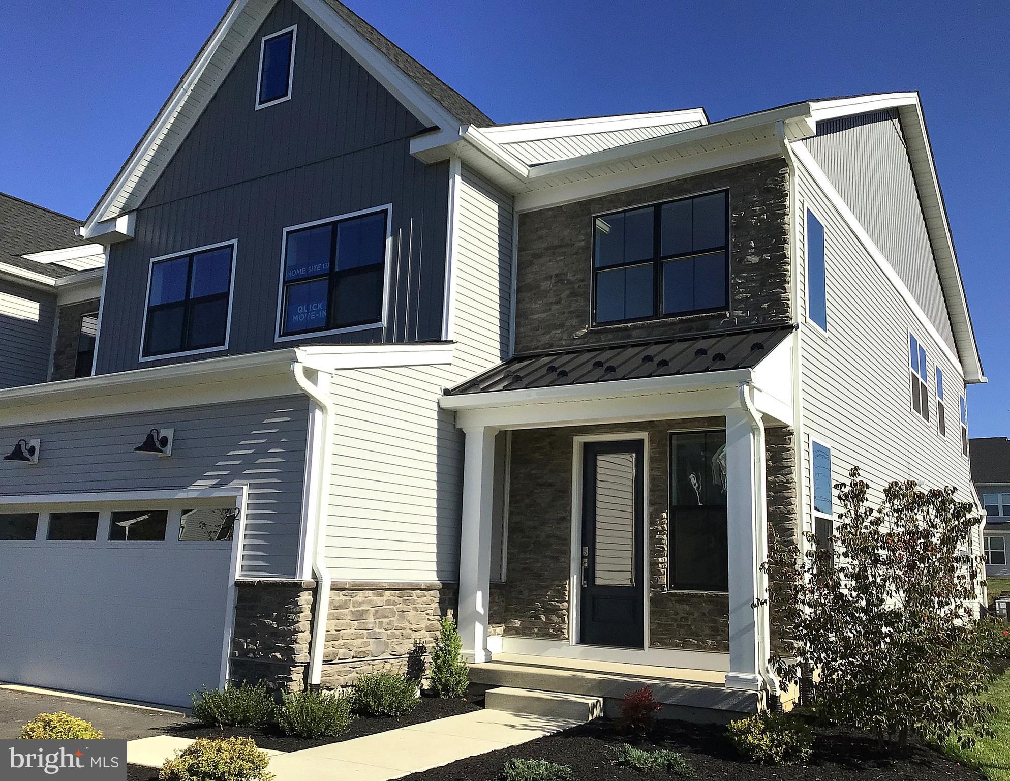 2 Mill Creek Drive, Unit 137 Doylestown, PA 18901 - Photo 2 of 17 a front view of a house with a garden