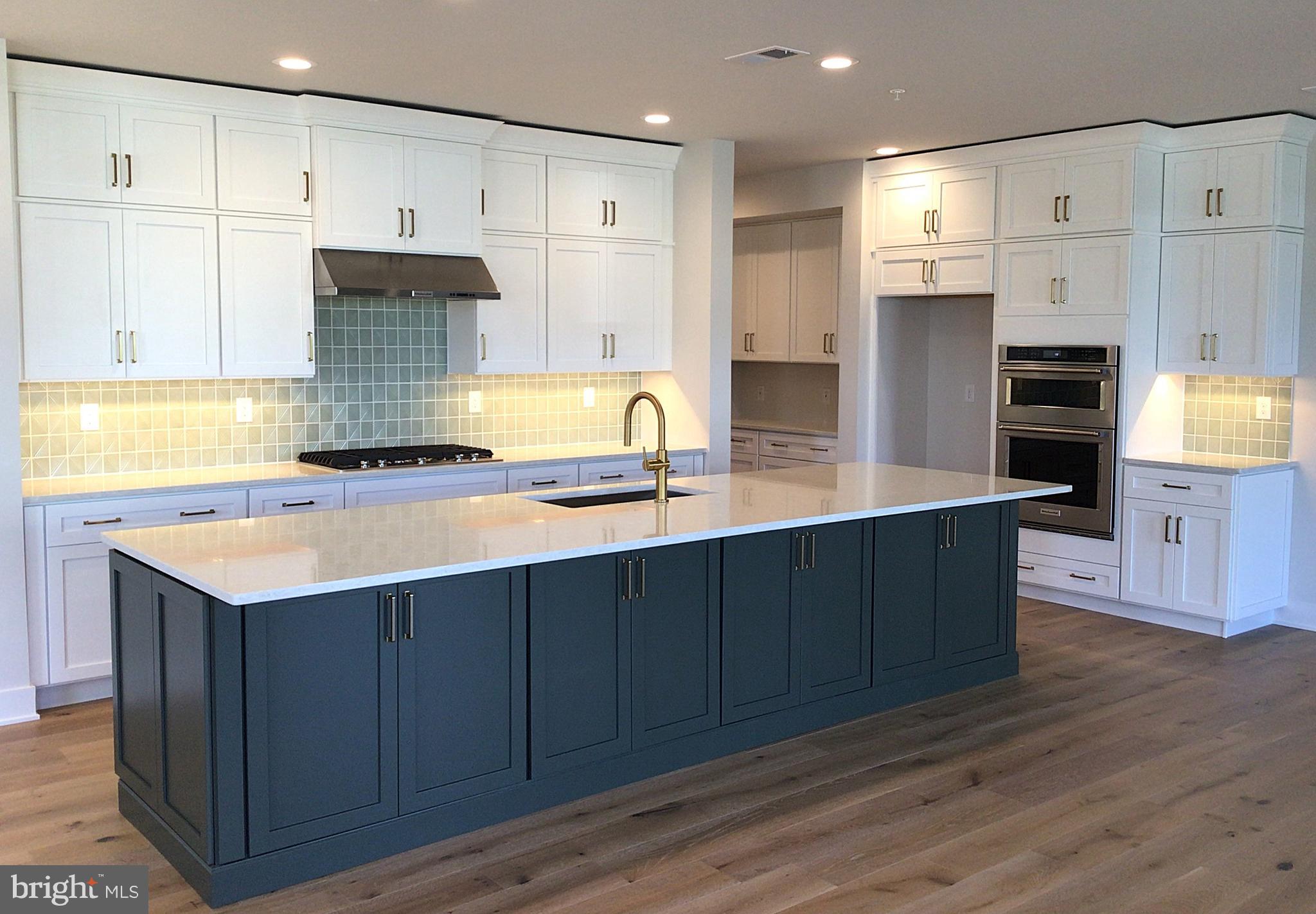 2 Mill Creek Drive, Unit 137 Doylestown, PA 18901 - Photo 3 of 17 a kitchen with stainless steel appliances granite countertop a sink a stove and a refrigerator