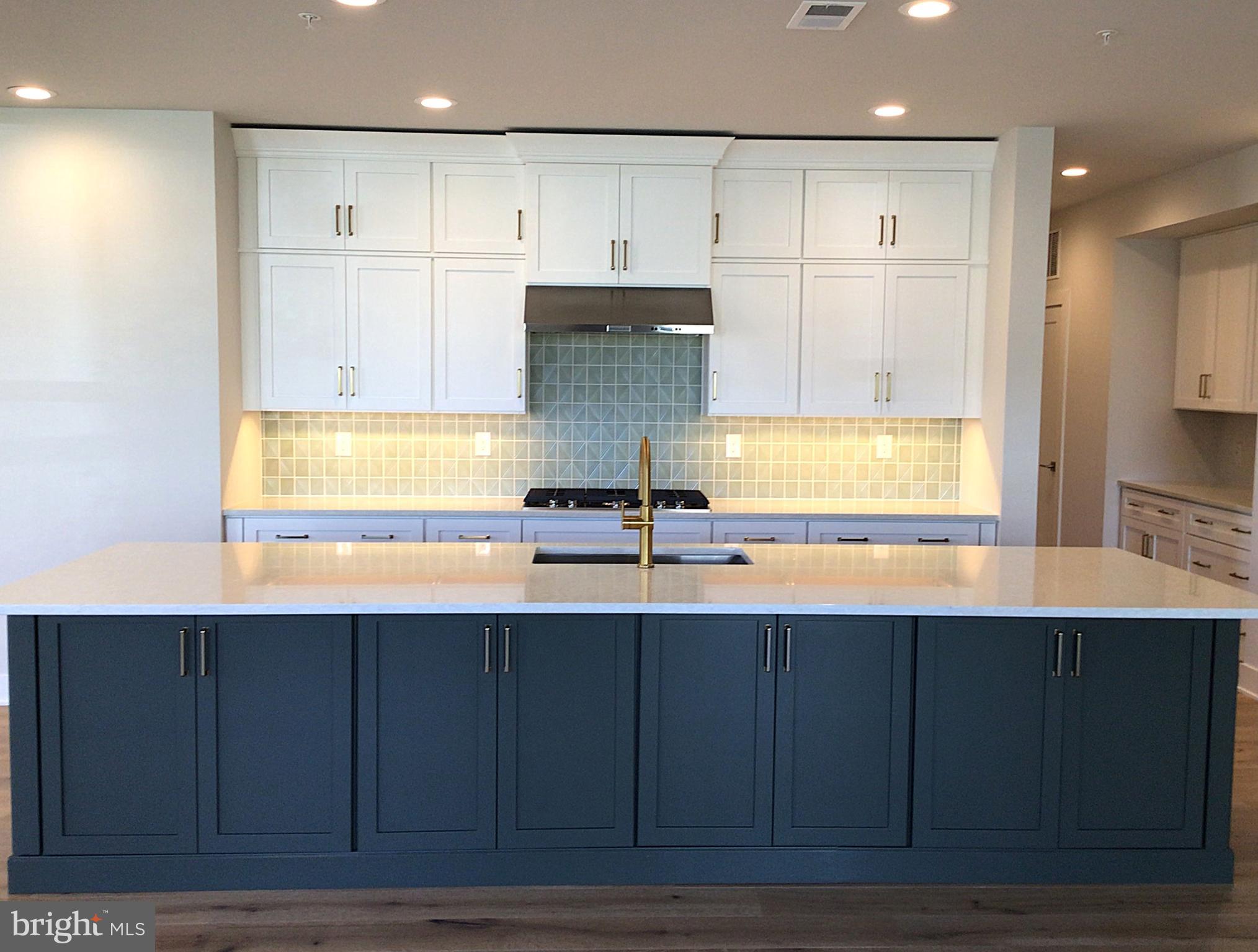 2 Mill Creek Drive, Unit 137 Doylestown, PA 18901 - Photo 4 of 17 a kitchen with stainless steel appliances granite countertop a sink and cabinets