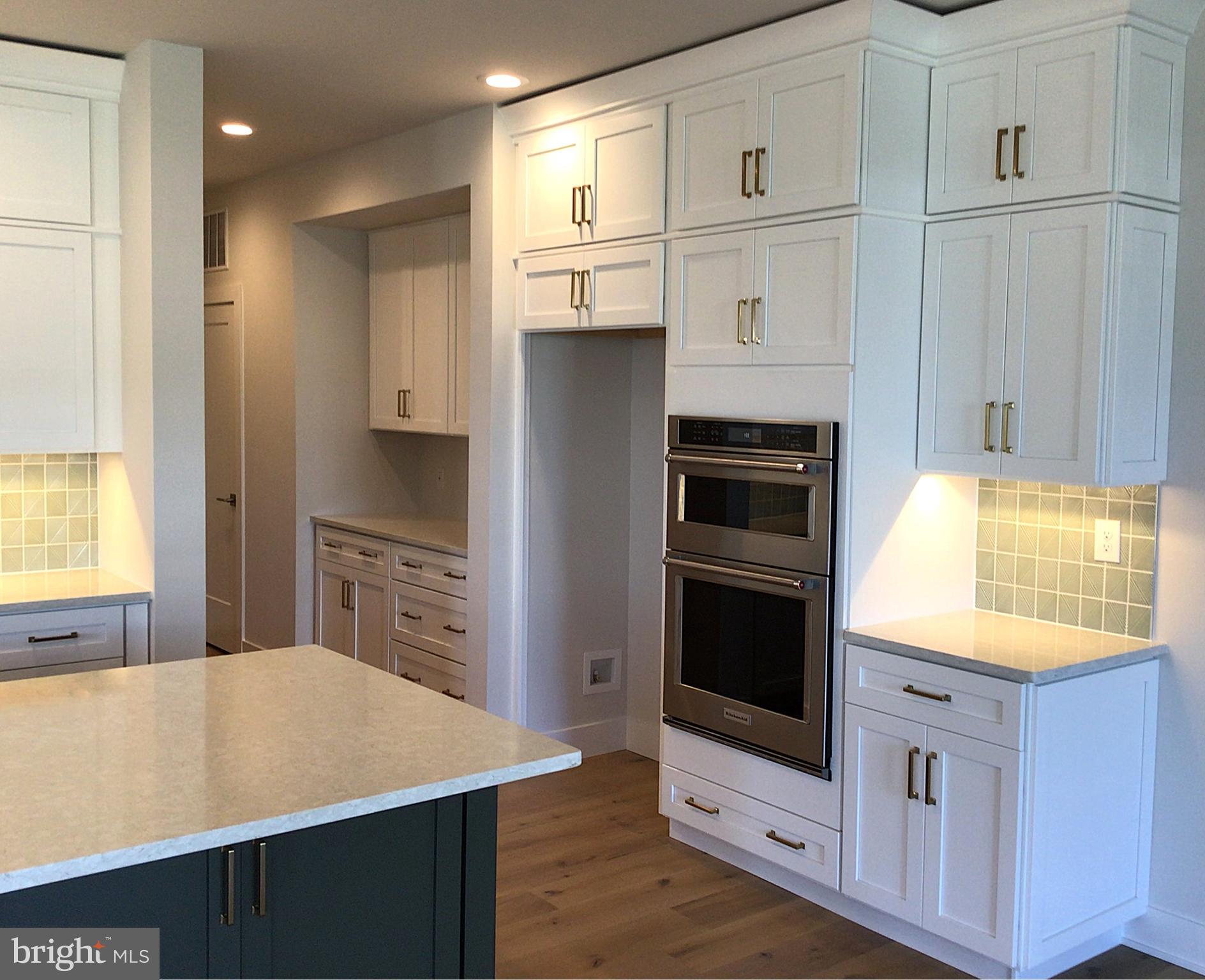 2 Mill Creek Drive, Unit 137 Doylestown, PA 18901 - Photo 5 of 17 a kitchen with stainless steel appliances a stove a microwave and a hard wood floors