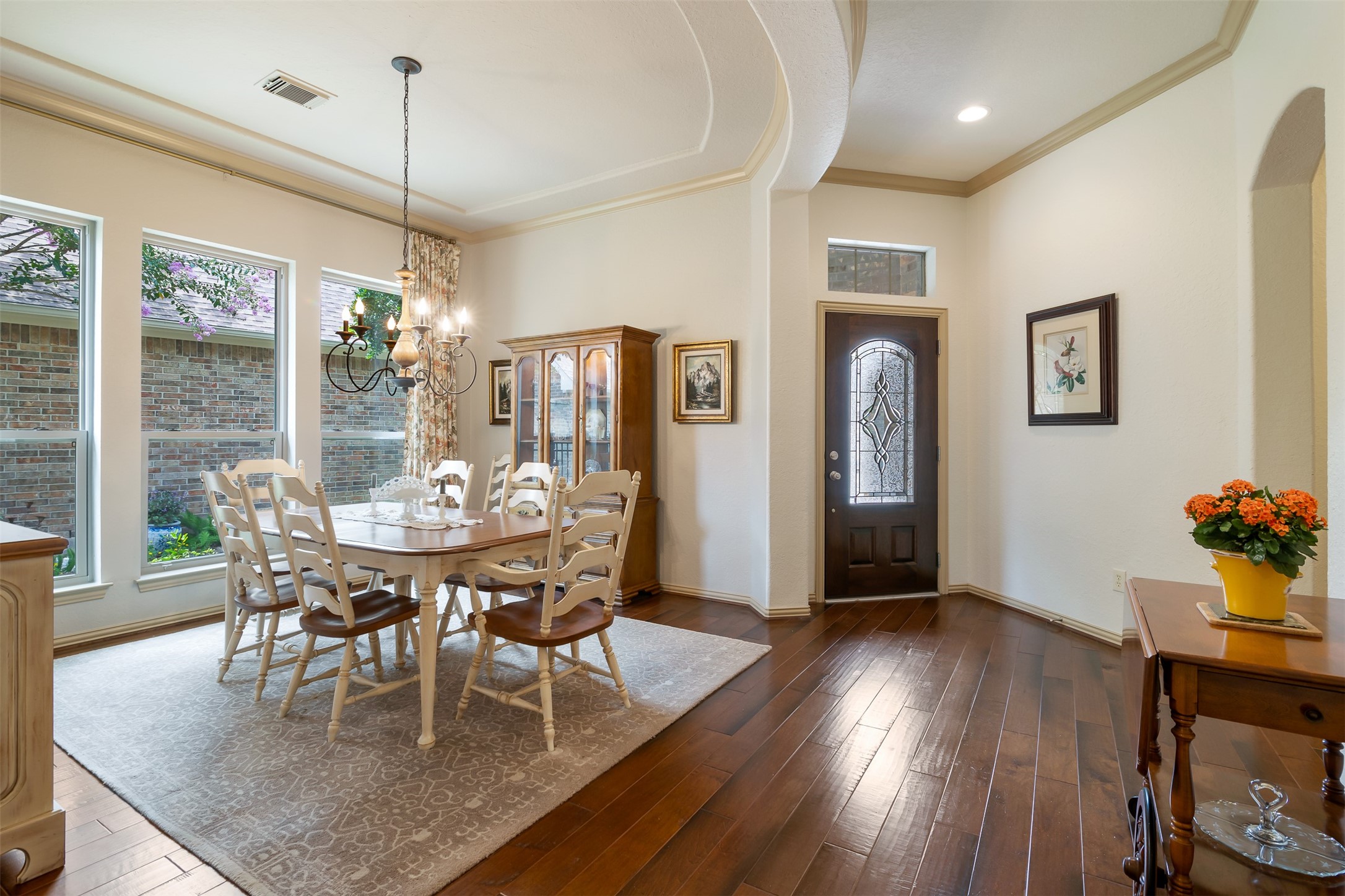 19507 Remington Manor Street Spring, TX 77379 - Photo 2 of 33 View of the dining room just off the foyer that features wood floors, tray ceiling with chandelier and crown molding.