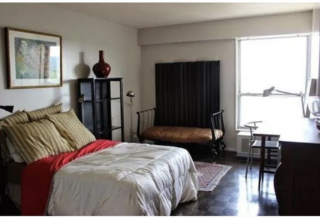 111 Perkins Street, Unit 108 Boston, MA 02130 - Photo 5 of 11 a bedroom with a bed and wooden floor