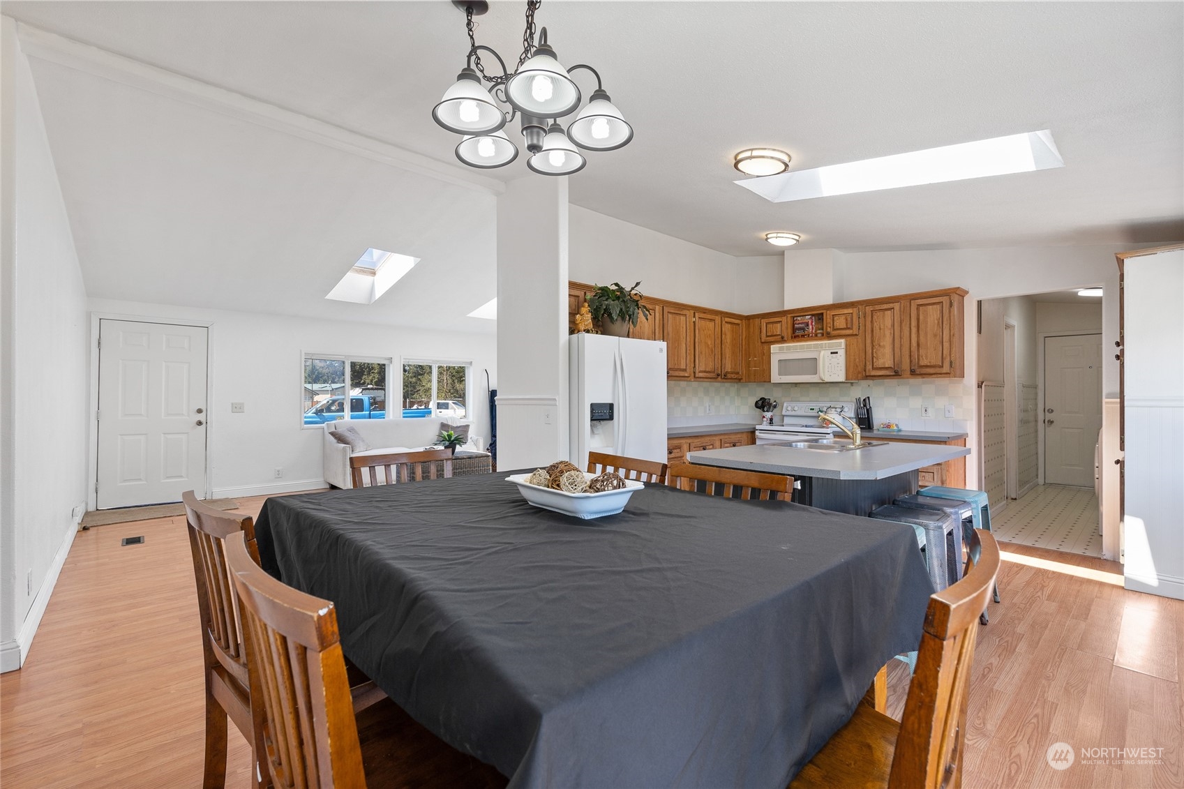17910 Michelles Lane Southwest Rochester, WA 98579 - Photo 8 of 35 a view of a dining room with furniture a chandelier and wooden floor