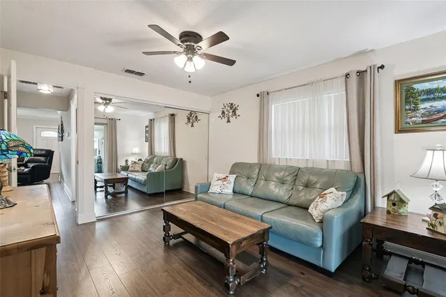 a living room with furniture and wooden floor