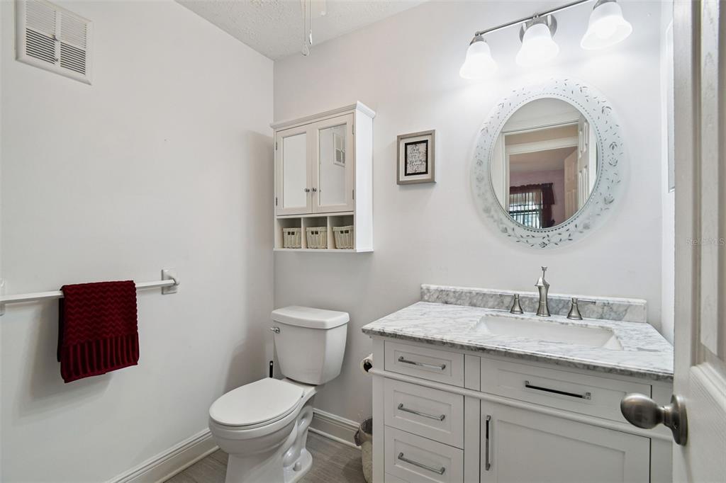 11902 Boynton Lane New Port Richey, FL 34654 - Photo 17 of 44 a bathroom with a toilet sink and mirror