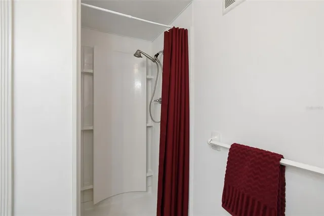 a bathroom with a shower and a mirror