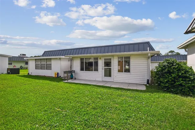 a view of a house with a backyard