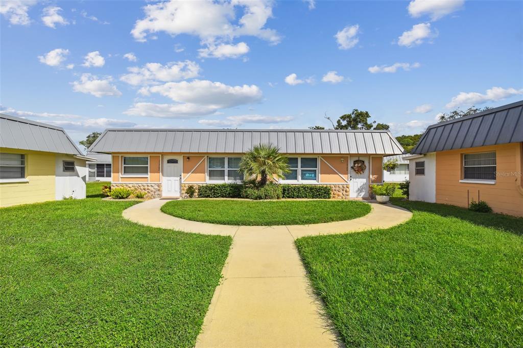 11902 Boynton Lane New Port Richey, FL 34654 - Photo 29 of 44 a view of a house with a big yard potted plants and large tree