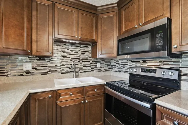 a kitchen with a sink stove and microwave