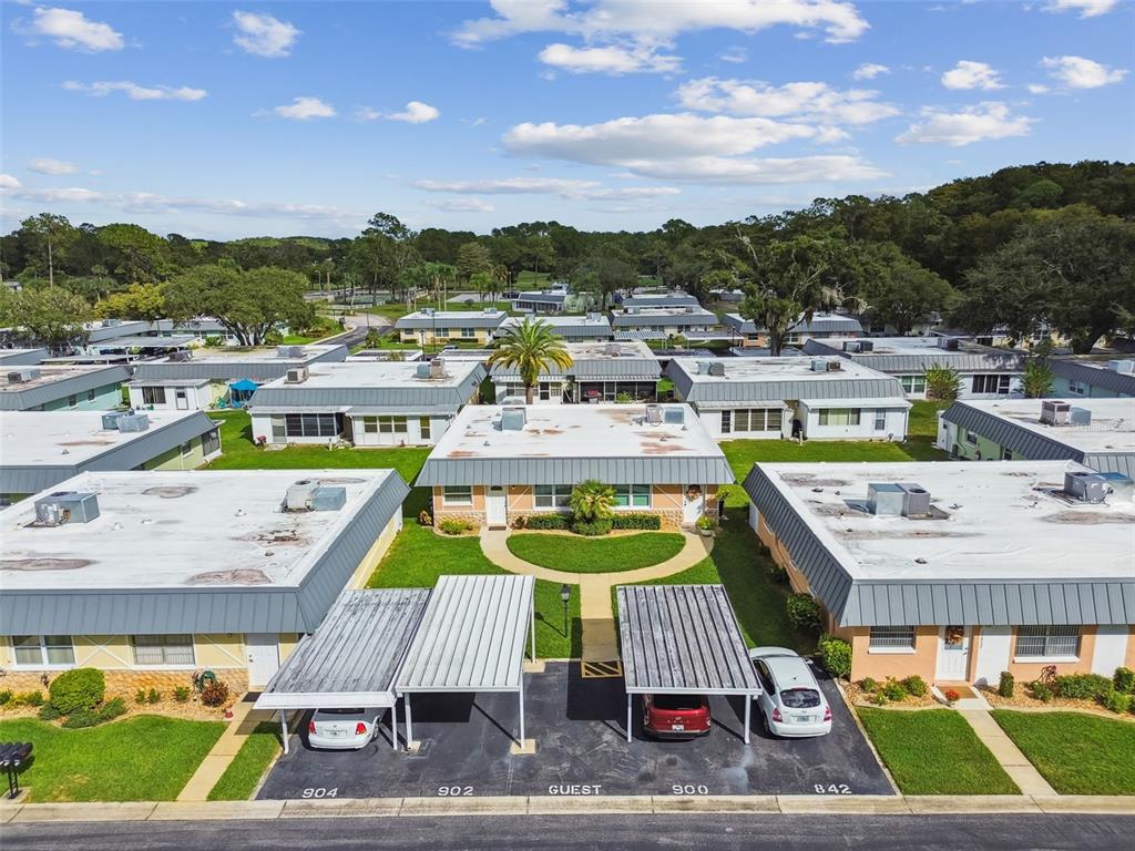 11902 Boynton Lane New Port Richey, FL 34654 - Photo 31 of 44 a view of a swimming pool with an outdoor seating a yard and mountain view