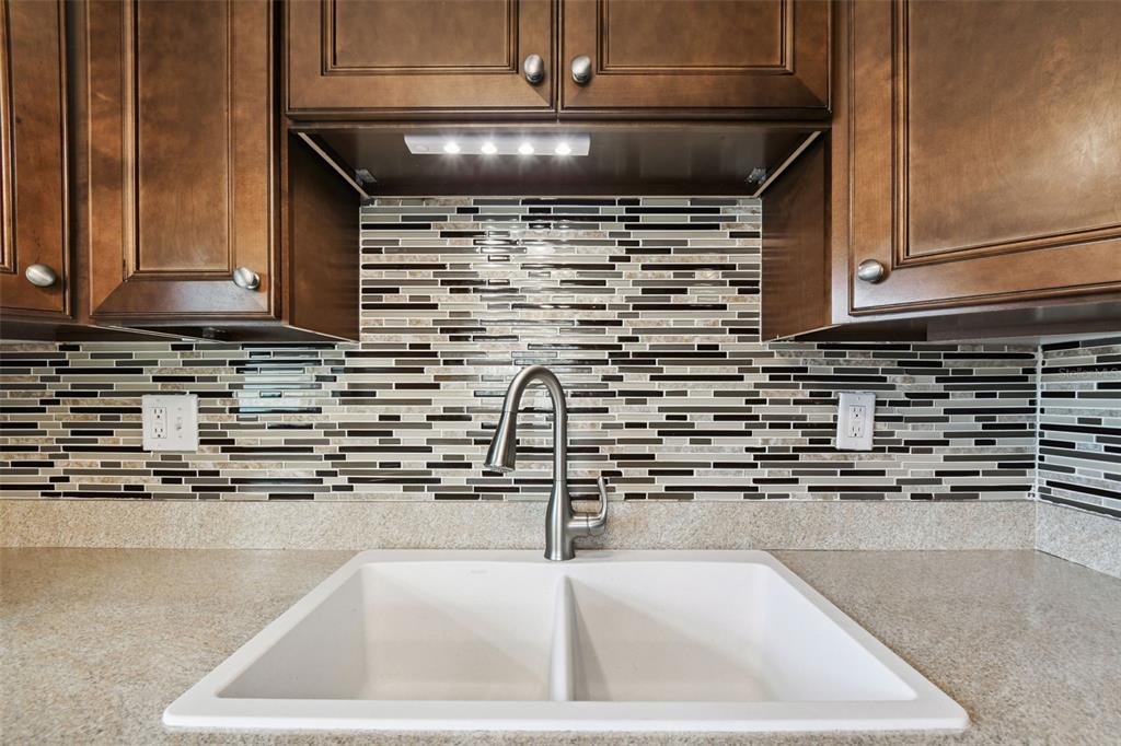 11902 Boynton Lane New Port Richey, FL 34654 - Photo 5 of 44 a kitchen with kitchen island a sink a stove and cabinets