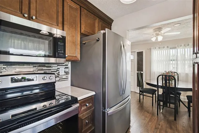 a kitchen with granite countertop a stove and a refrigerator