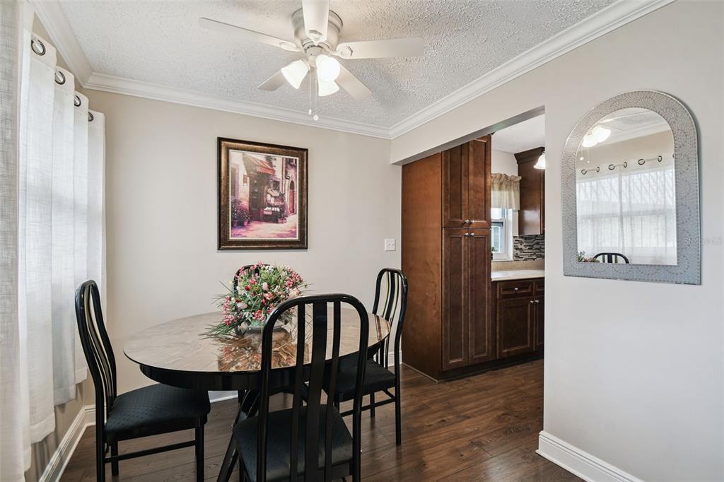 11902 Boynton Lane New Port Richey, FL 34654 - Photo 7 of 44 a view of a a dining room with furniture window and wooden floor