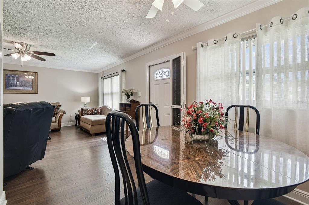11902 Boynton Lane New Port Richey, FL 34654 - Photo 9 of 44 a view of a a dining room with furniture window and wooden floor