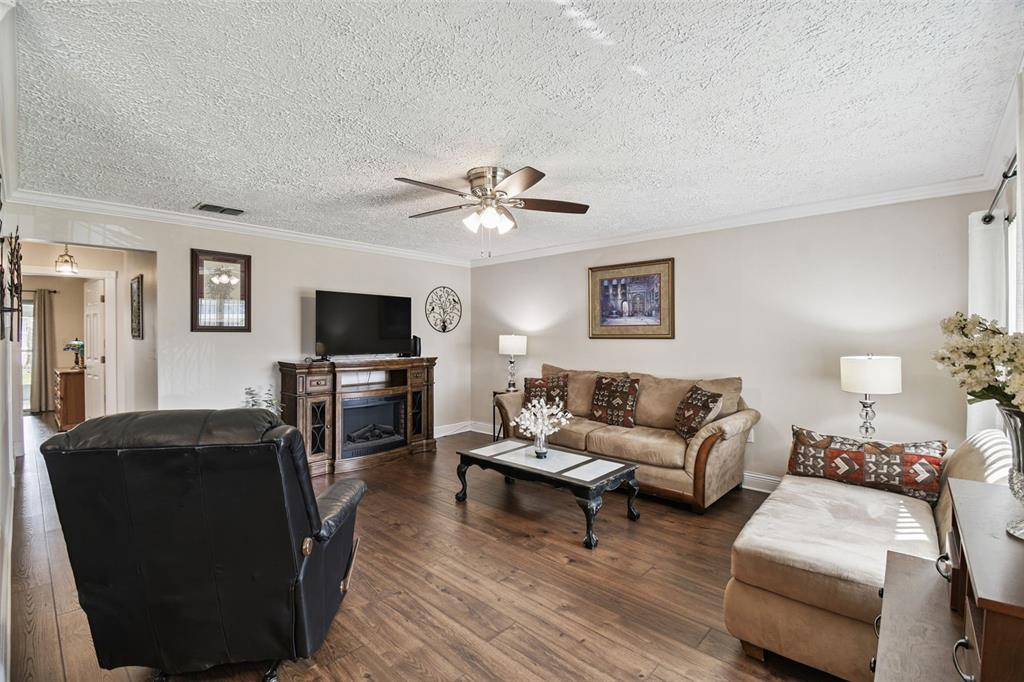 11902 Boynton Lane New Port Richey, FL 34654 - Photo 10 of 44 a living room with furniture and a flat screen tv