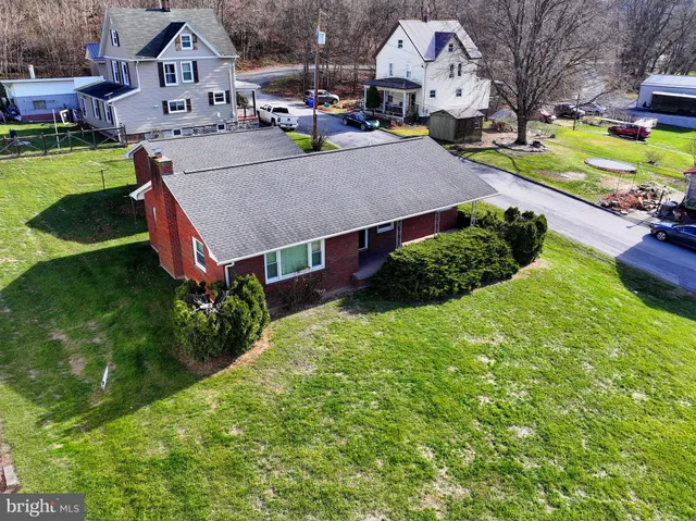 an aerial view of a house with swimming pool garden and patio