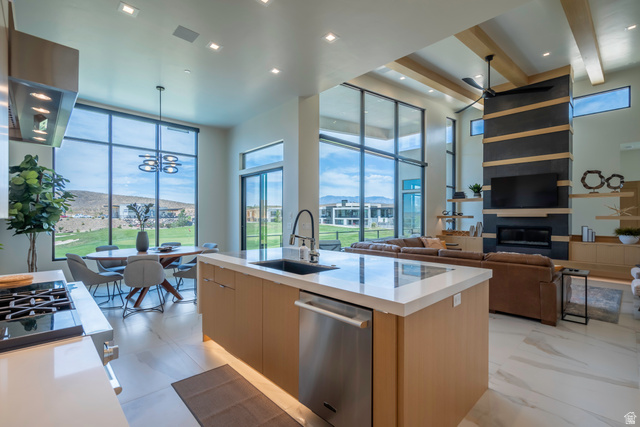 3606 South Cypress Road Hurricane, UT 84737 - Photo 18 of 69 Kitchen with modern cabinets, light stone counters, a kitchen island with sink, stainless steel appliances, and range hood