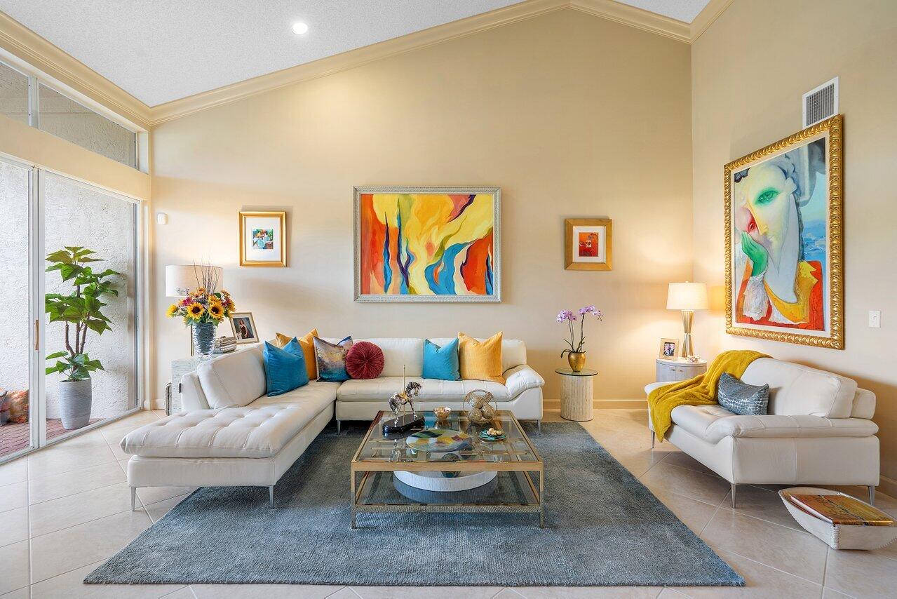 a living room with furniture and painting on the wall