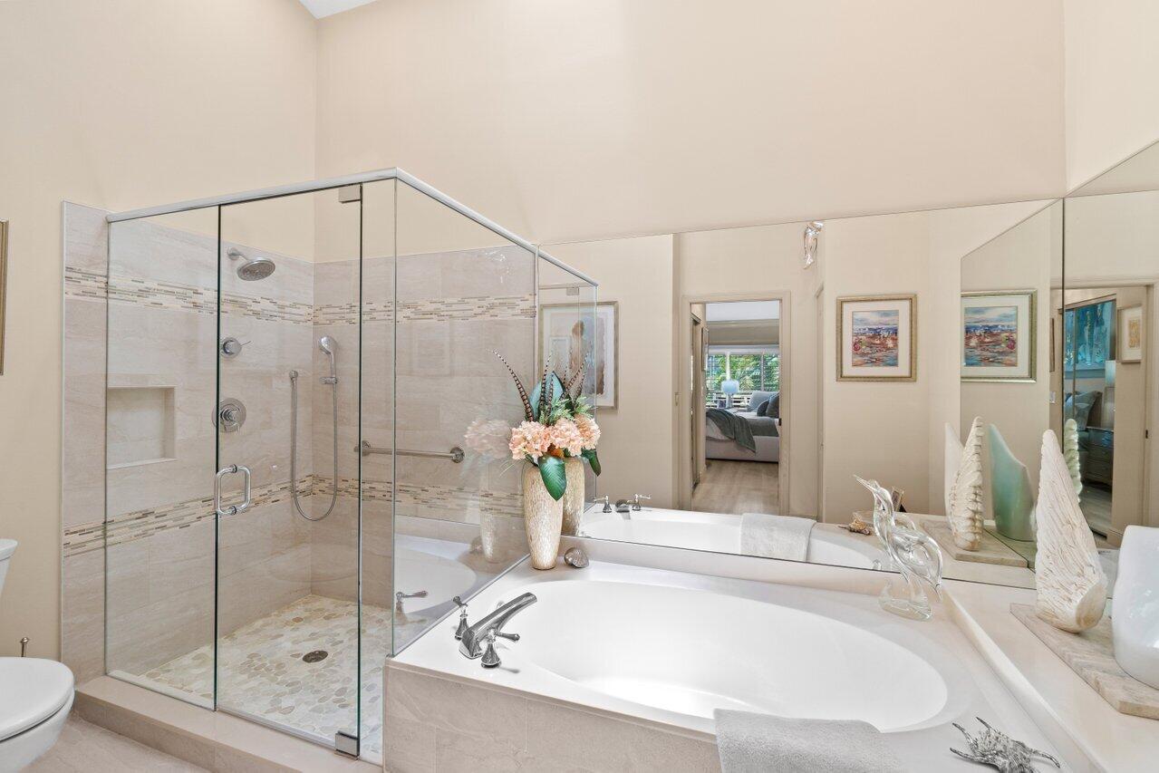 5158 Windsor Parke Drive Boca Raton, FL 33496 - Photo 18 of 44 a bathroom with a bathtub and a shower