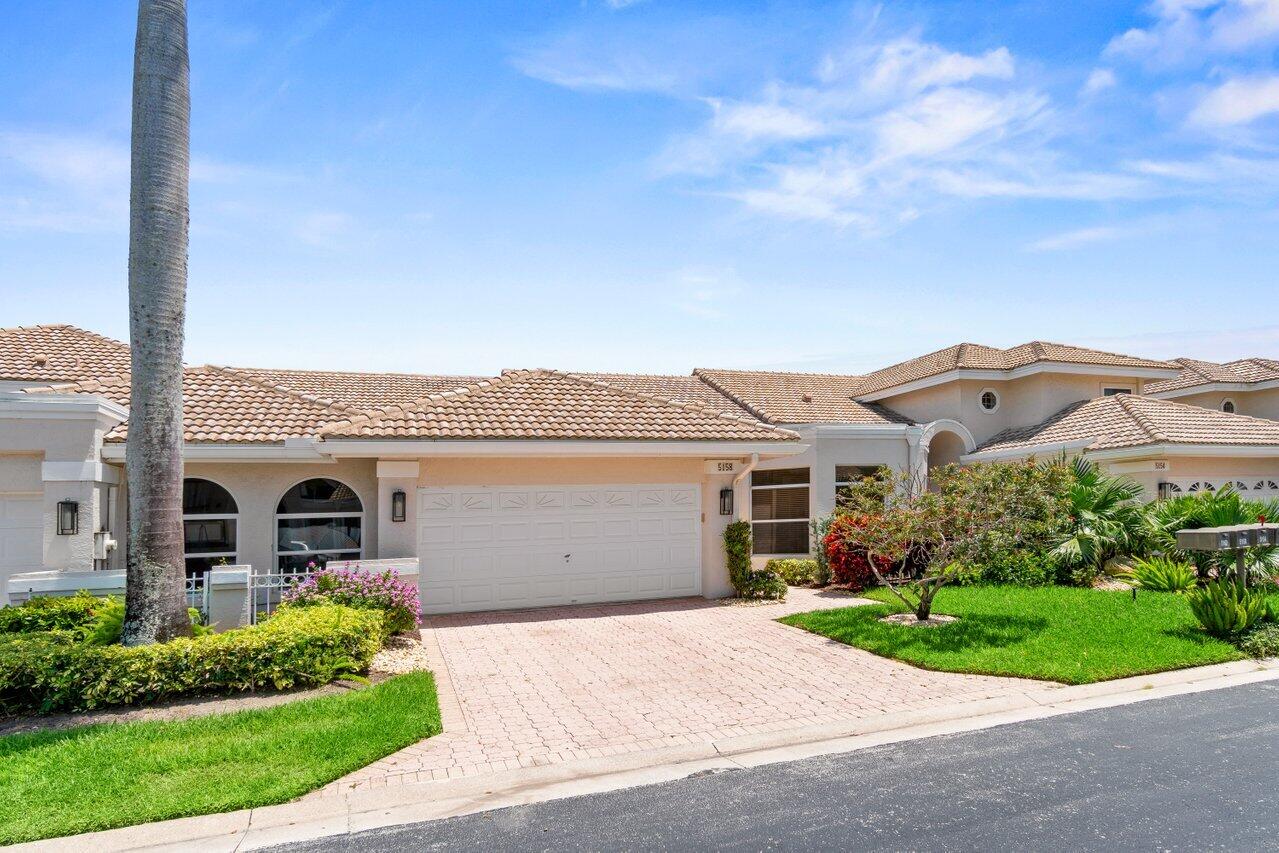 5158 Windsor Parke Drive Boca Raton, FL 33496 - Photo 23 of 44 front view of a house with a garden