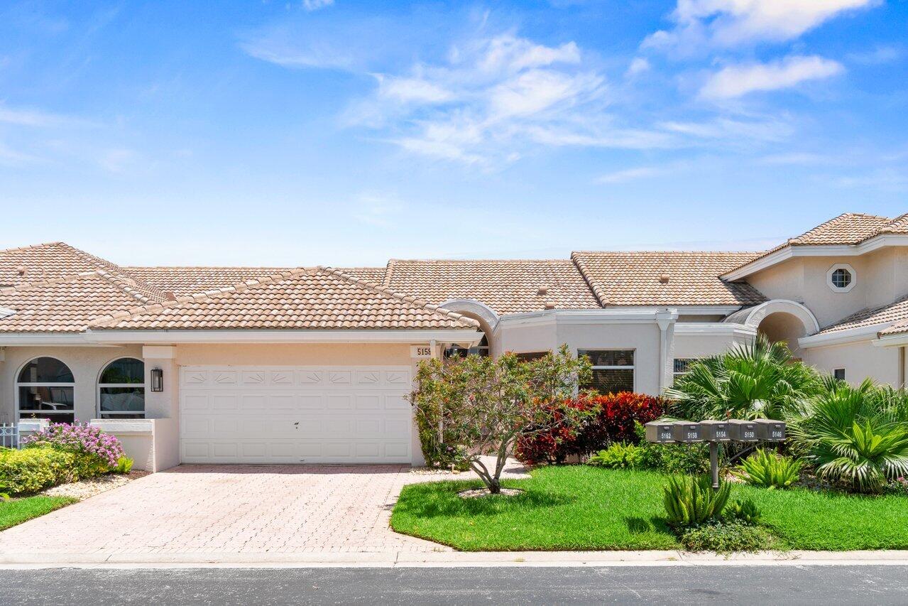 5158 Windsor Parke Drive Boca Raton, FL 33496 - Photo 24 of 44 a front view of a house with a yard and garage