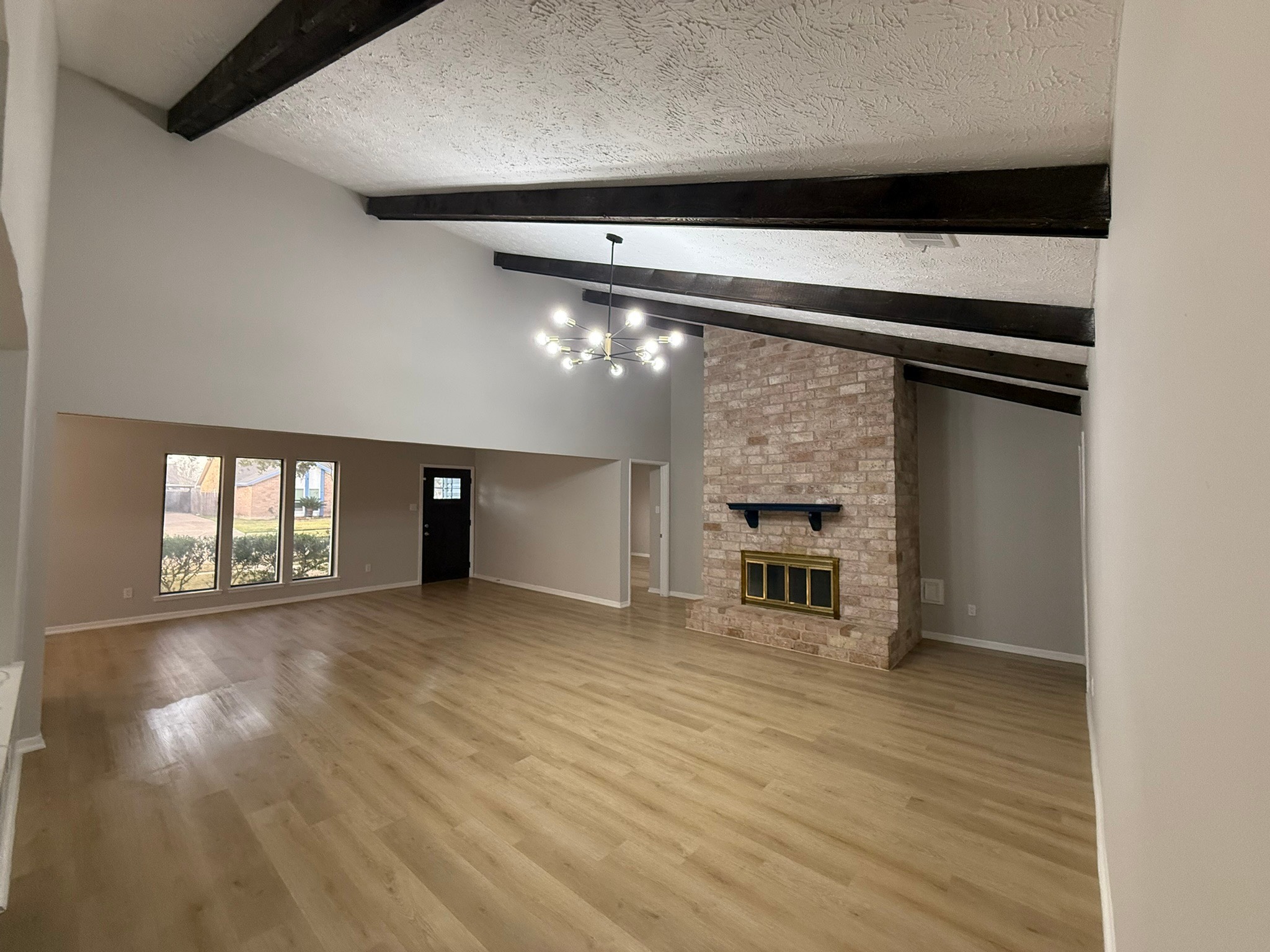 10130 Sagedale Drive Houston, TX 77089 - Photo 15 of 36 a view of empty room with wooden floor and fireplace