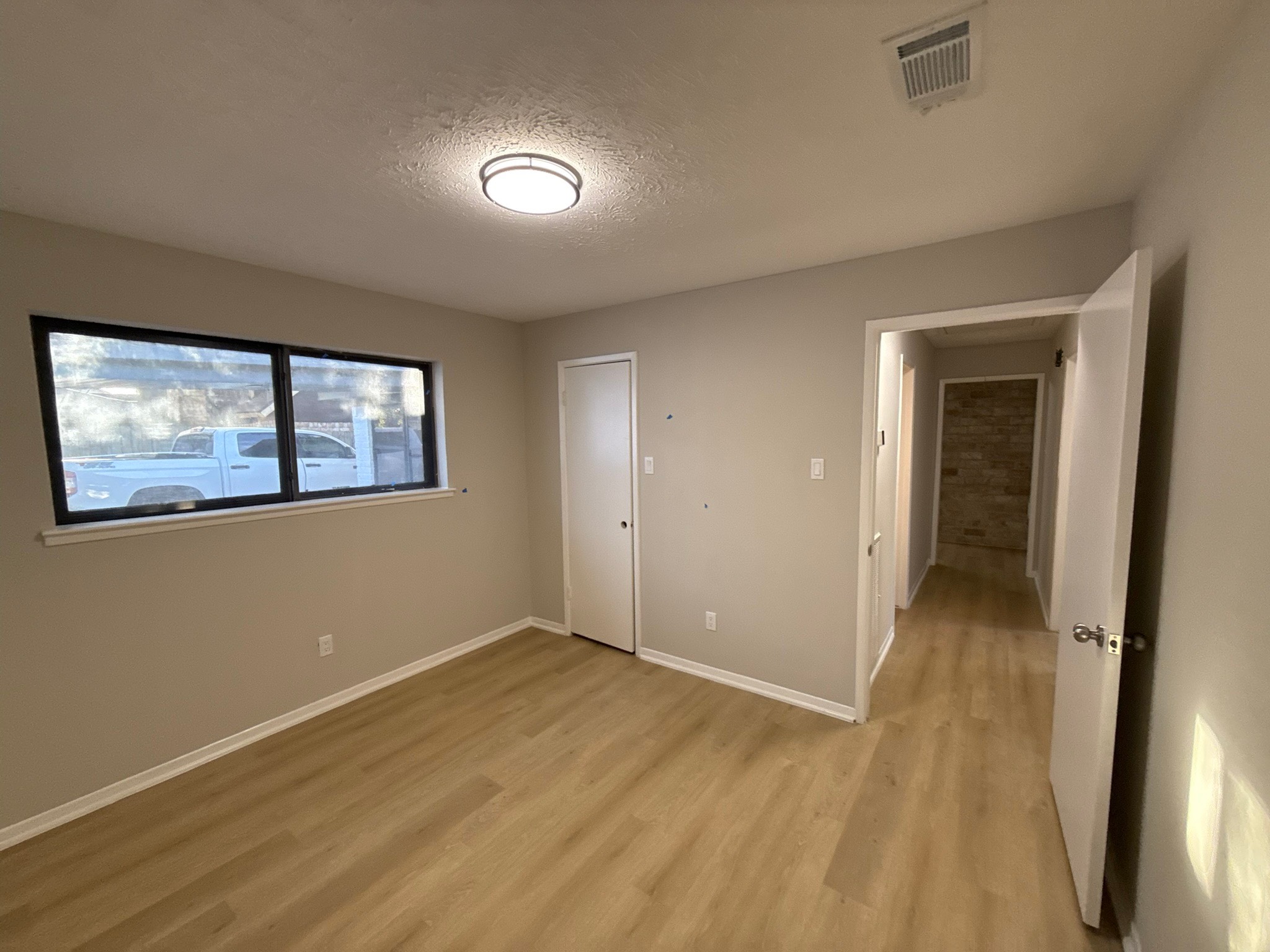 10130 Sagedale Drive Houston, TX 77089 - Photo 25 of 36 a view of an empty room with wooden floor and a window