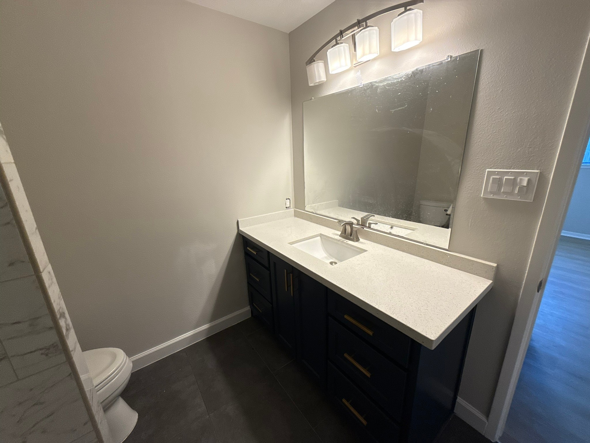 10130 Sagedale Drive Houston, TX 77089 - Photo 28 of 36 a bathroom with a sink a toilet and a mirror