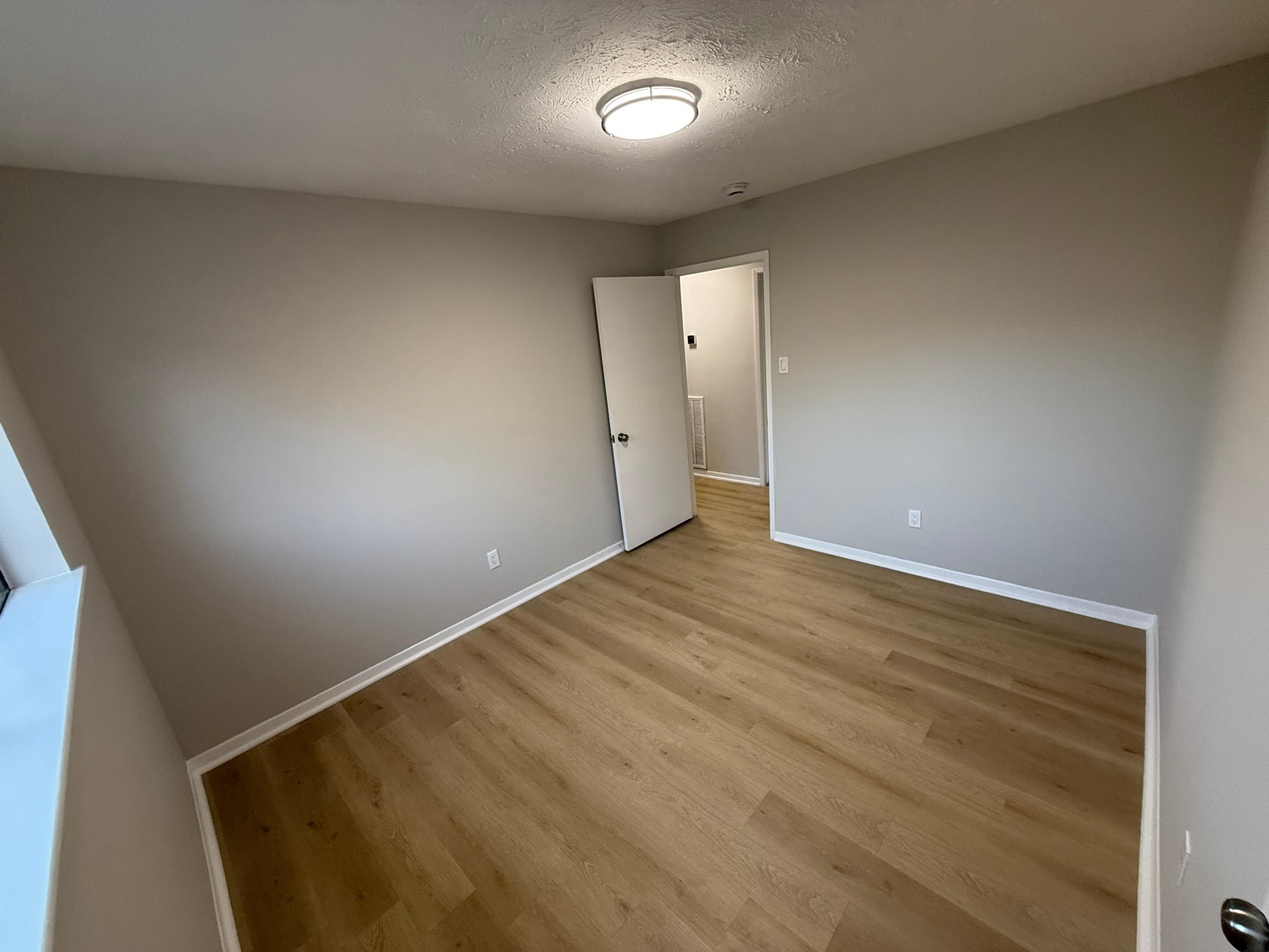 10130 Sagedale Drive Houston, TX 77089 - Photo 31 of 36 an empty room with wooden floor and windows