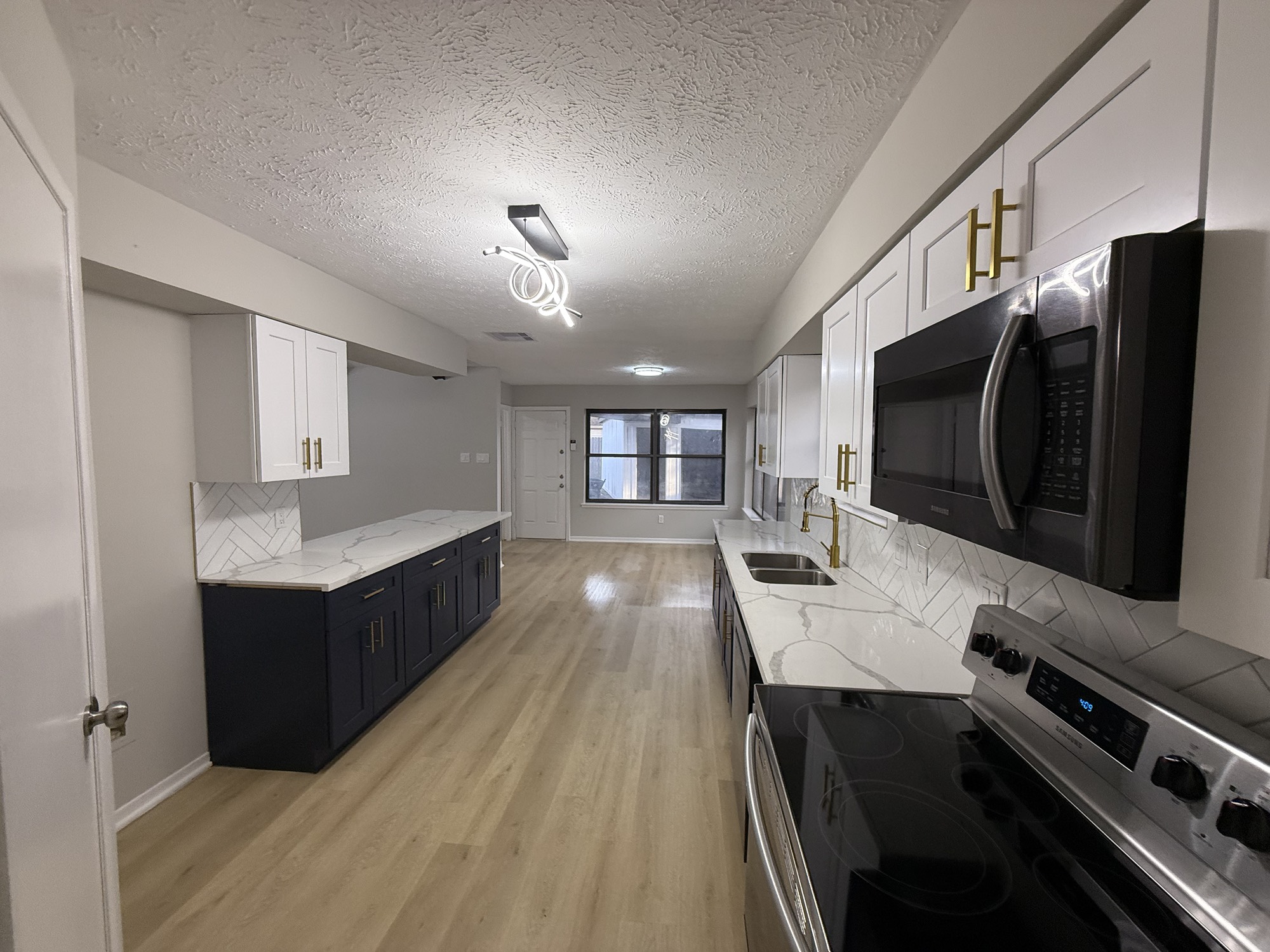 10130 Sagedale Drive Houston, TX 77089 - Photo 8 of 36 a kitchen with stainless steel appliances a stove cabinets and wooden floor