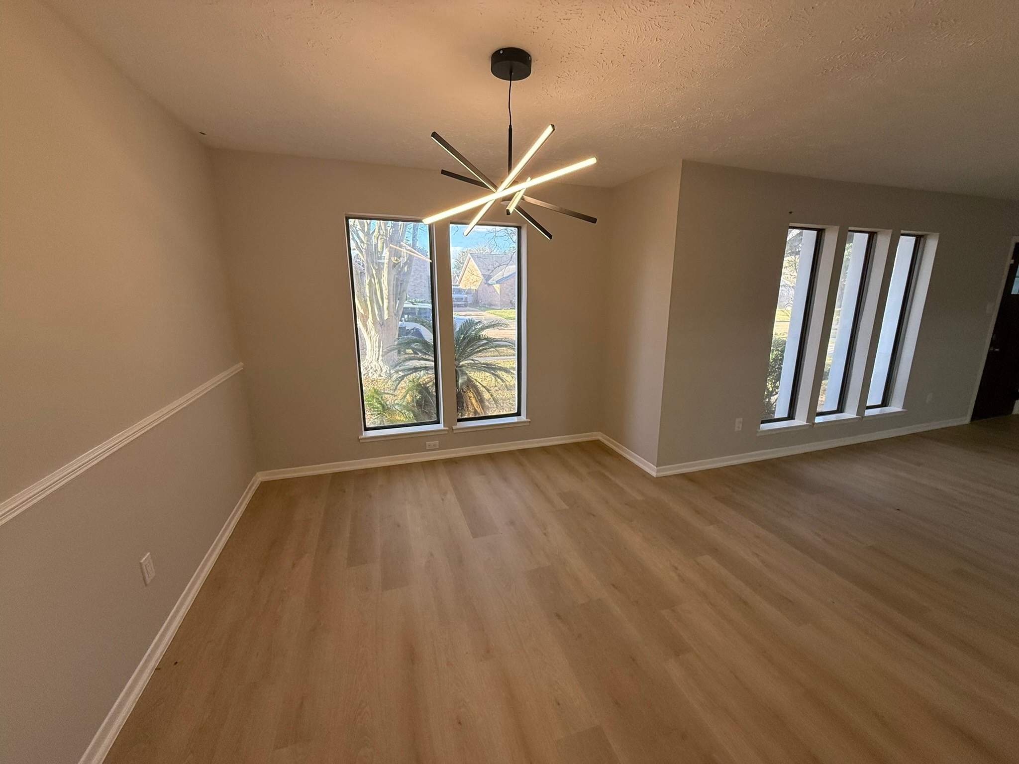 10130 Sagedale Drive Houston, TX 77089 - Photo 10 of 36 an empty room with wooden floor fan and windows