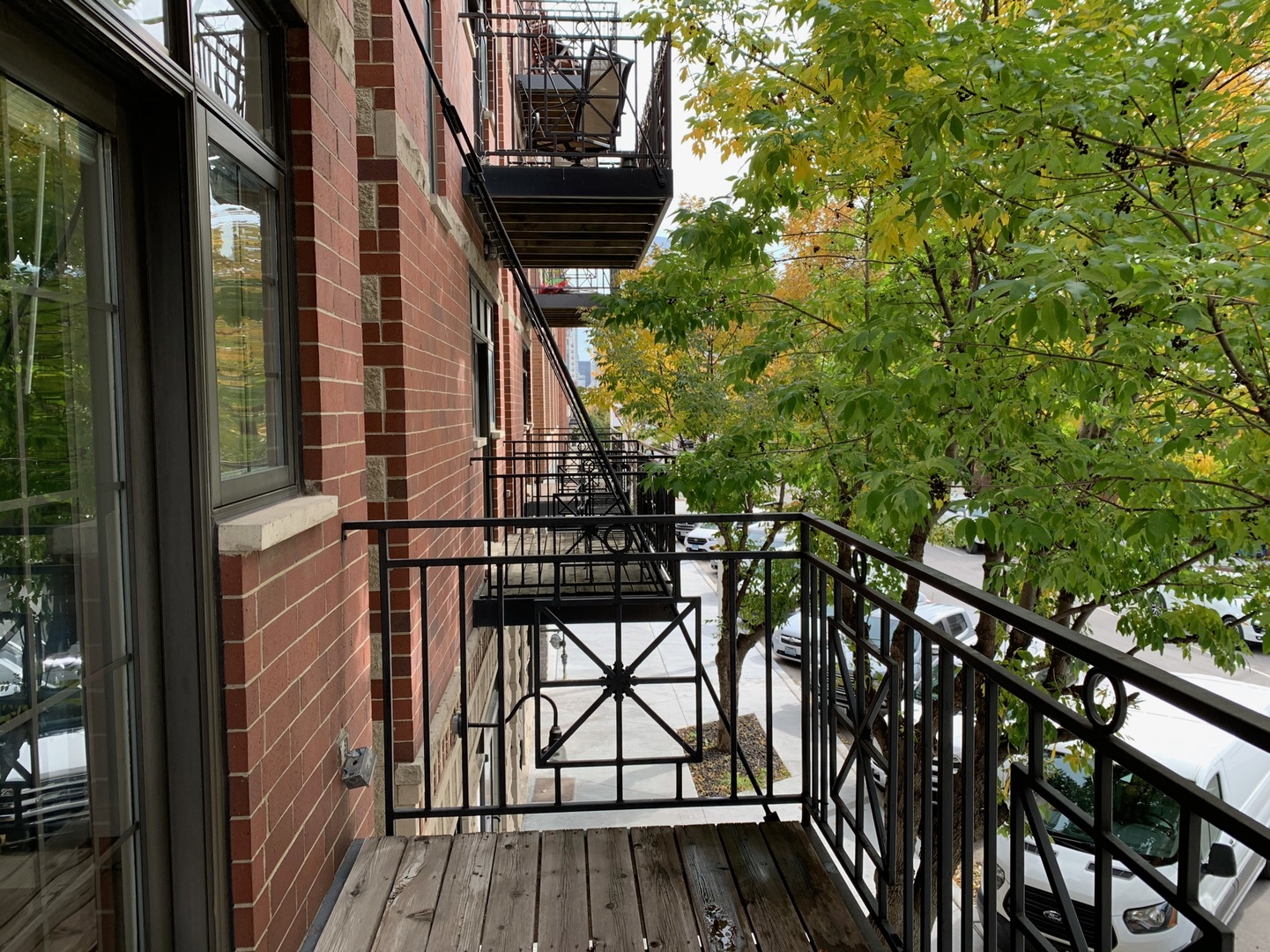 1048 West Fulton Street, Unit 2 Chicago, IL 60607 - Photo 17 of 22 a view of balcony with wooden floor and fence