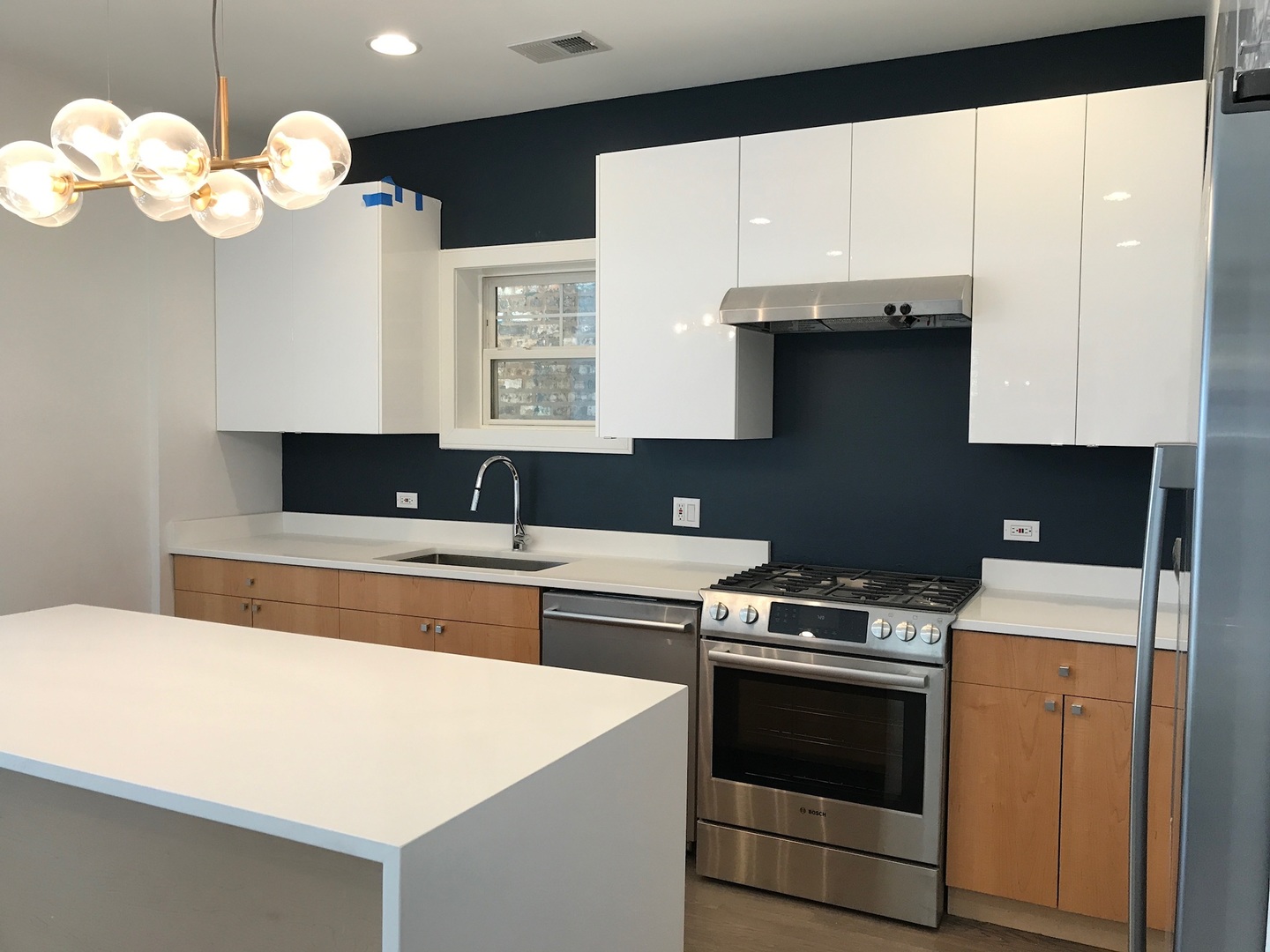 1048 West Fulton Street, Unit 2 Chicago, IL 60607 - Photo 9 of 22 a kitchen with a stove and a white cabinet