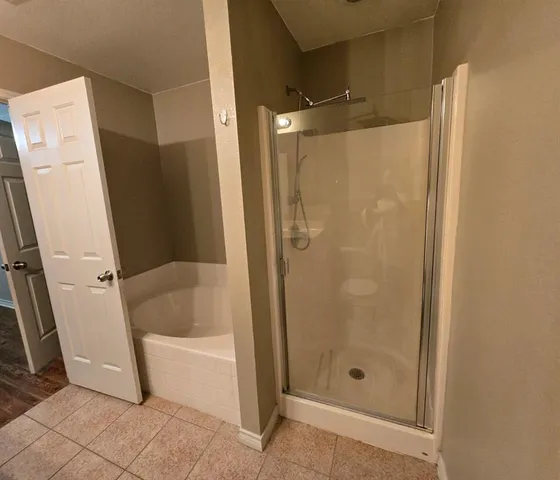 a bathroom with a glass shower door