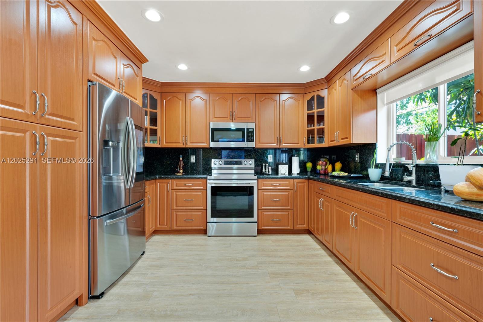 10006 Southwest 162nd Path Miami, FL 33196 - Photo 14 of 40 a kitchen with granite countertop stainless steel appliances and counter space