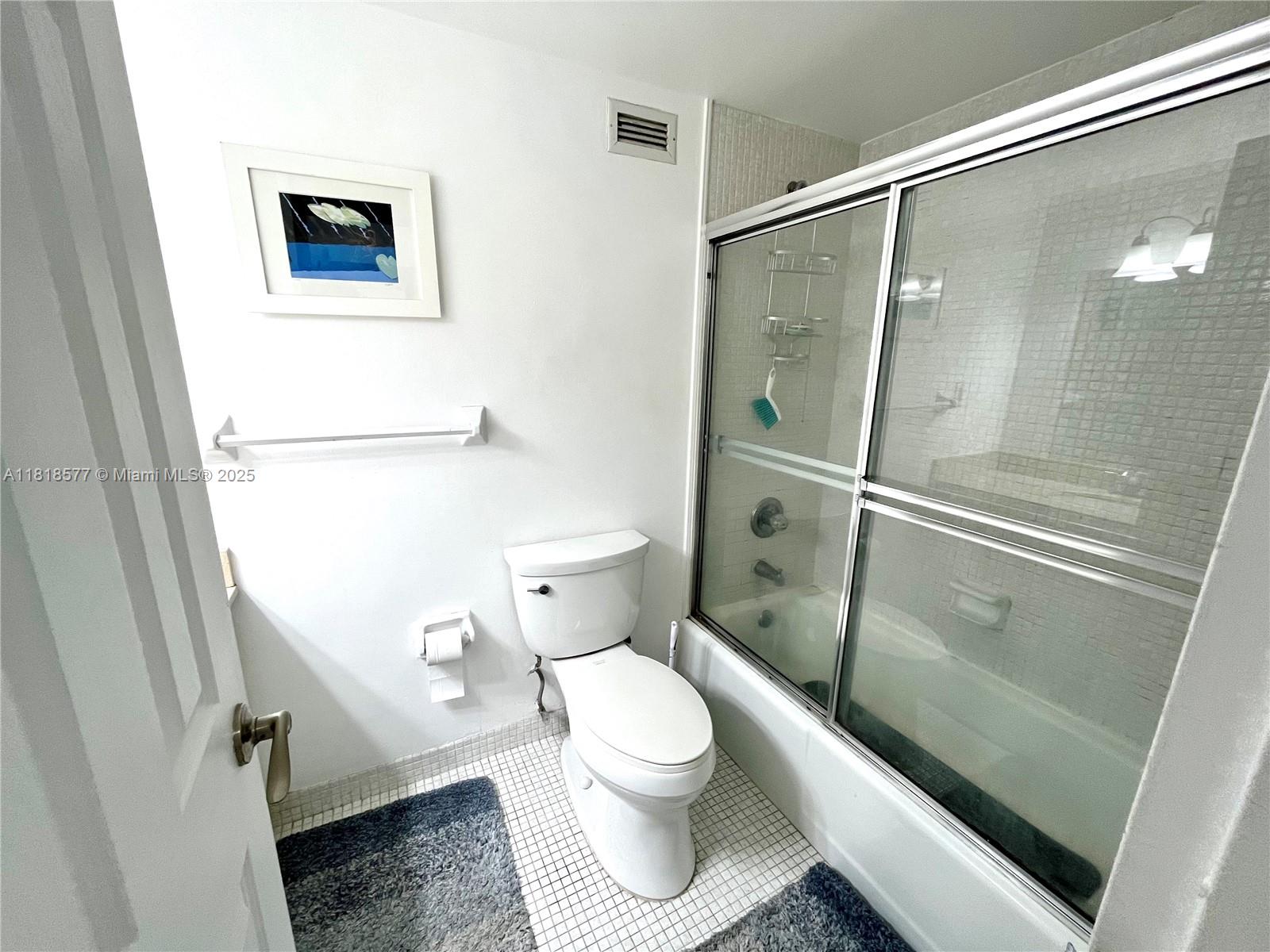 2899 Collins Avenue, Unit 810 Miami Beach, FL 33140 - Photo 11 of 36 a bathroom with a toilet and a shower