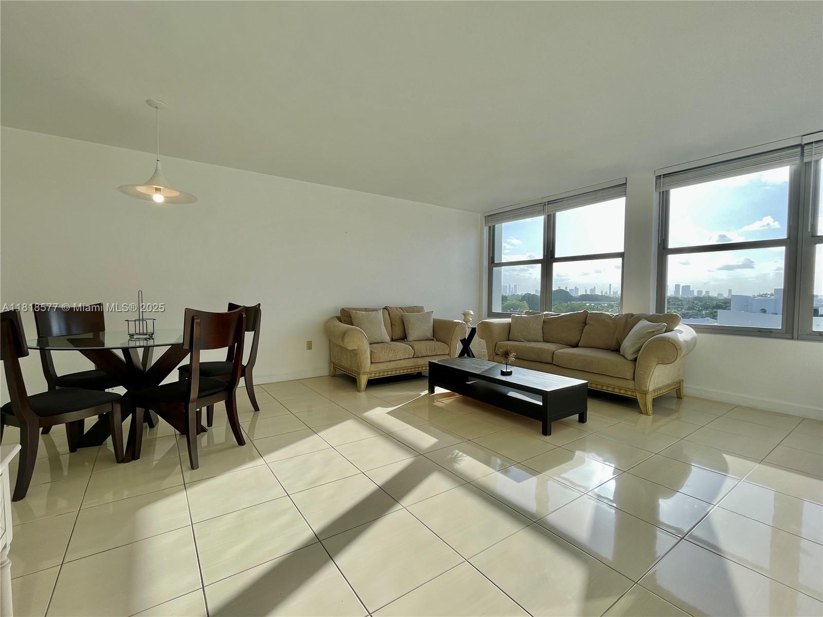 2899 Collins Avenue, Unit 810 Miami Beach, FL 33140 - Photo 2 of 36 a living room with furniture and a large window