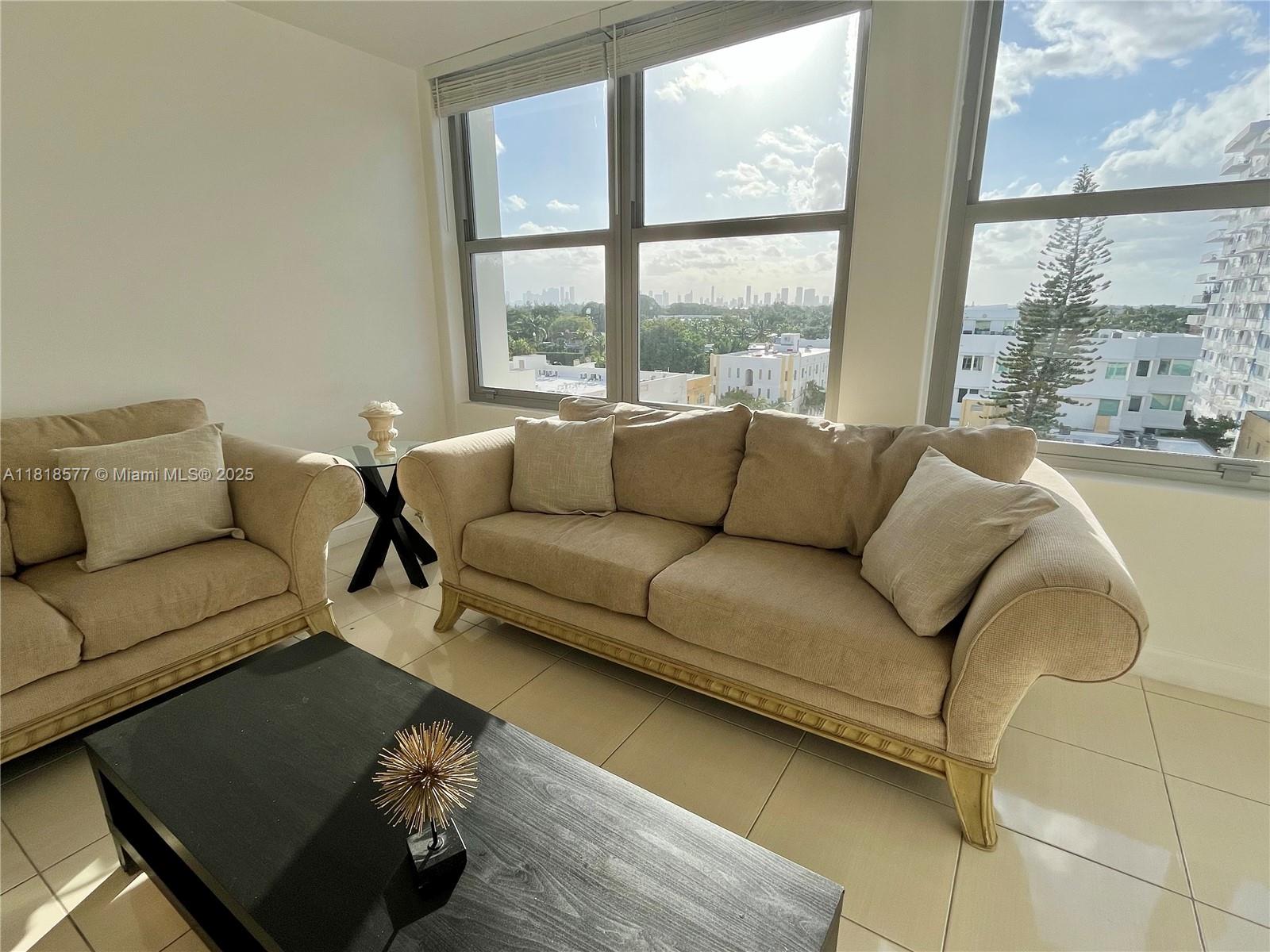 2899 Collins Avenue, Unit 810 Miami Beach, FL 33140 - Photo 7 of 36 a living room with furniture and a large window