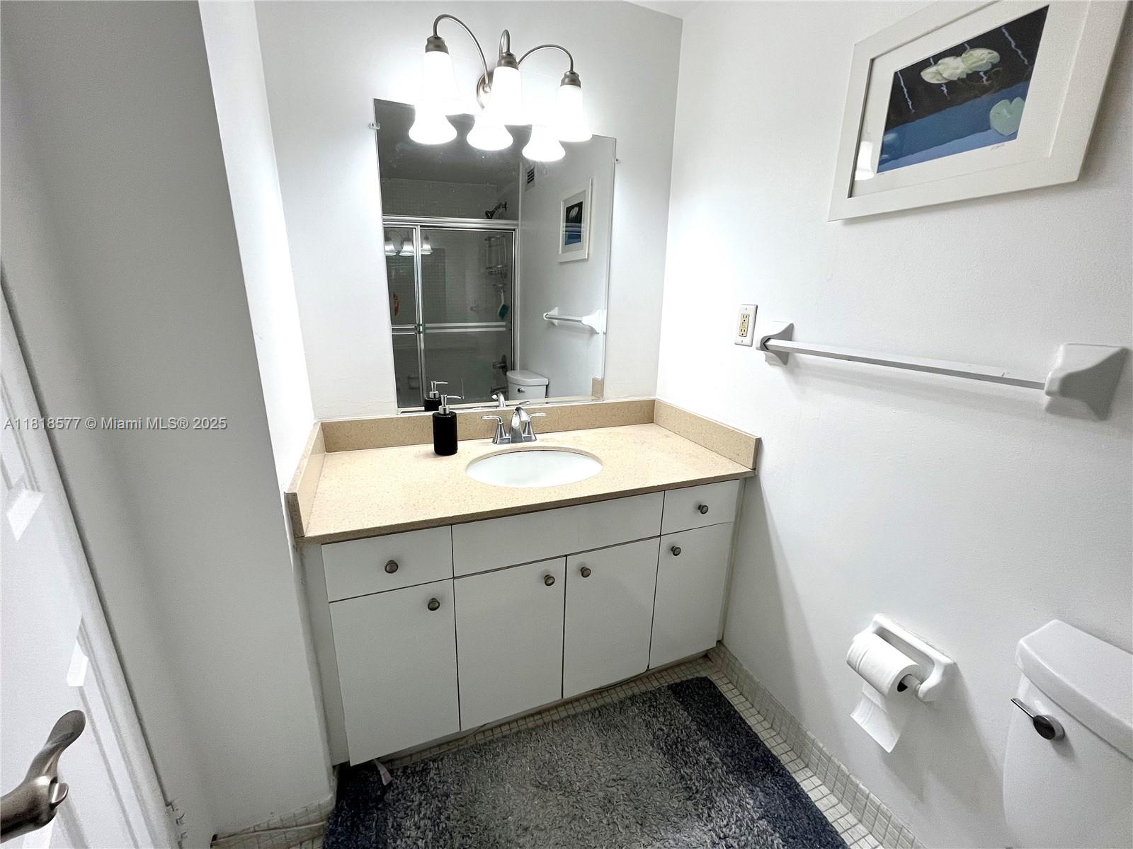 2899 Collins Avenue, Unit 810 Miami Beach, FL 33140 - Photo 10 of 36 a spacious bathroom with a double vanity sink and a mirror