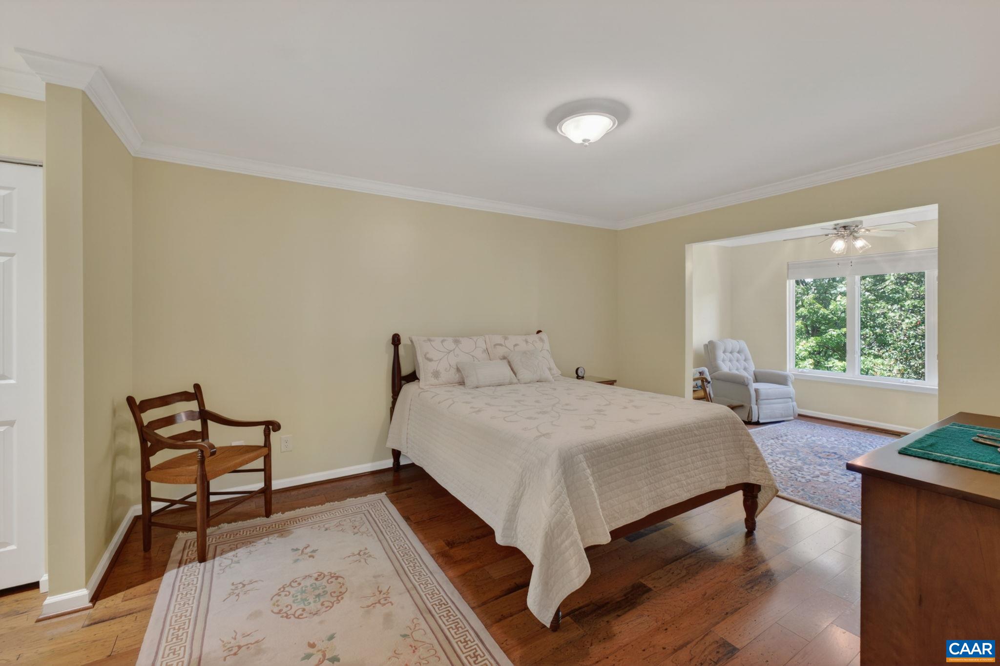 590 Mockingbird Way Charlottesville, VA 22901 - Photo 21 of 43 a bed sitting in a spacious bedroom next to a window