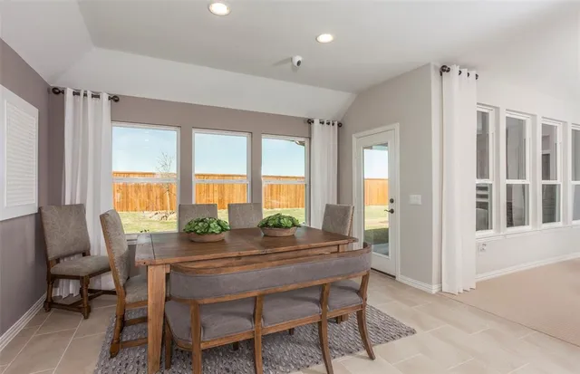 a dining room with furniture and window