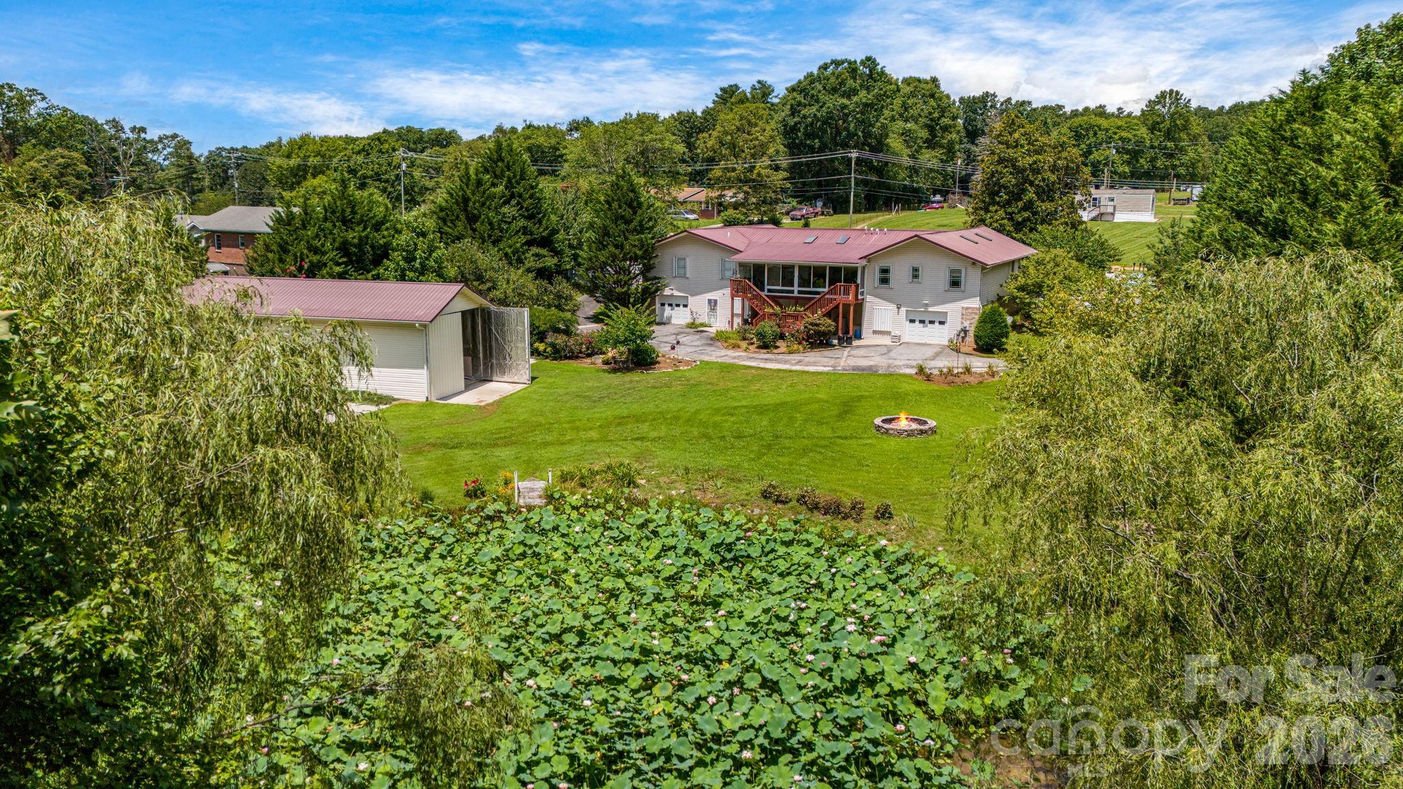 an aerial view of a house with a yard basket ball court and outdoor seating