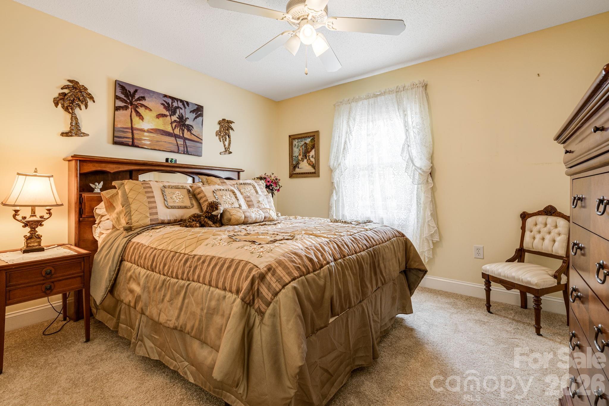 350 Old Sunset Hill Road Hendersonville, NC 28792 - Photo 19 of 40 a bedroom with a bed chair and window