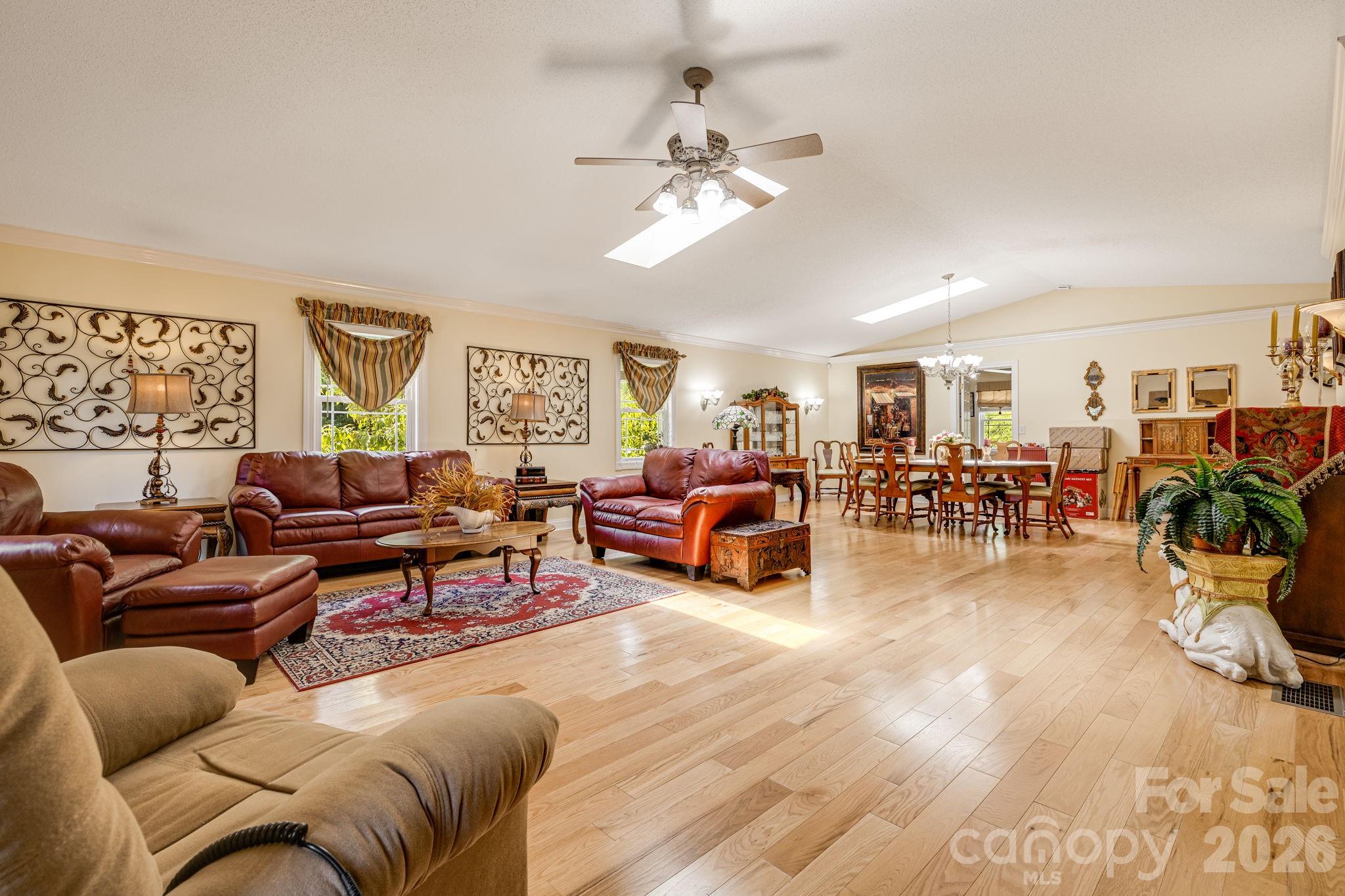 350 Old Sunset Hill Road Hendersonville, NC 28792 - Photo 2 of 40 a living room with furniture and a chandelier