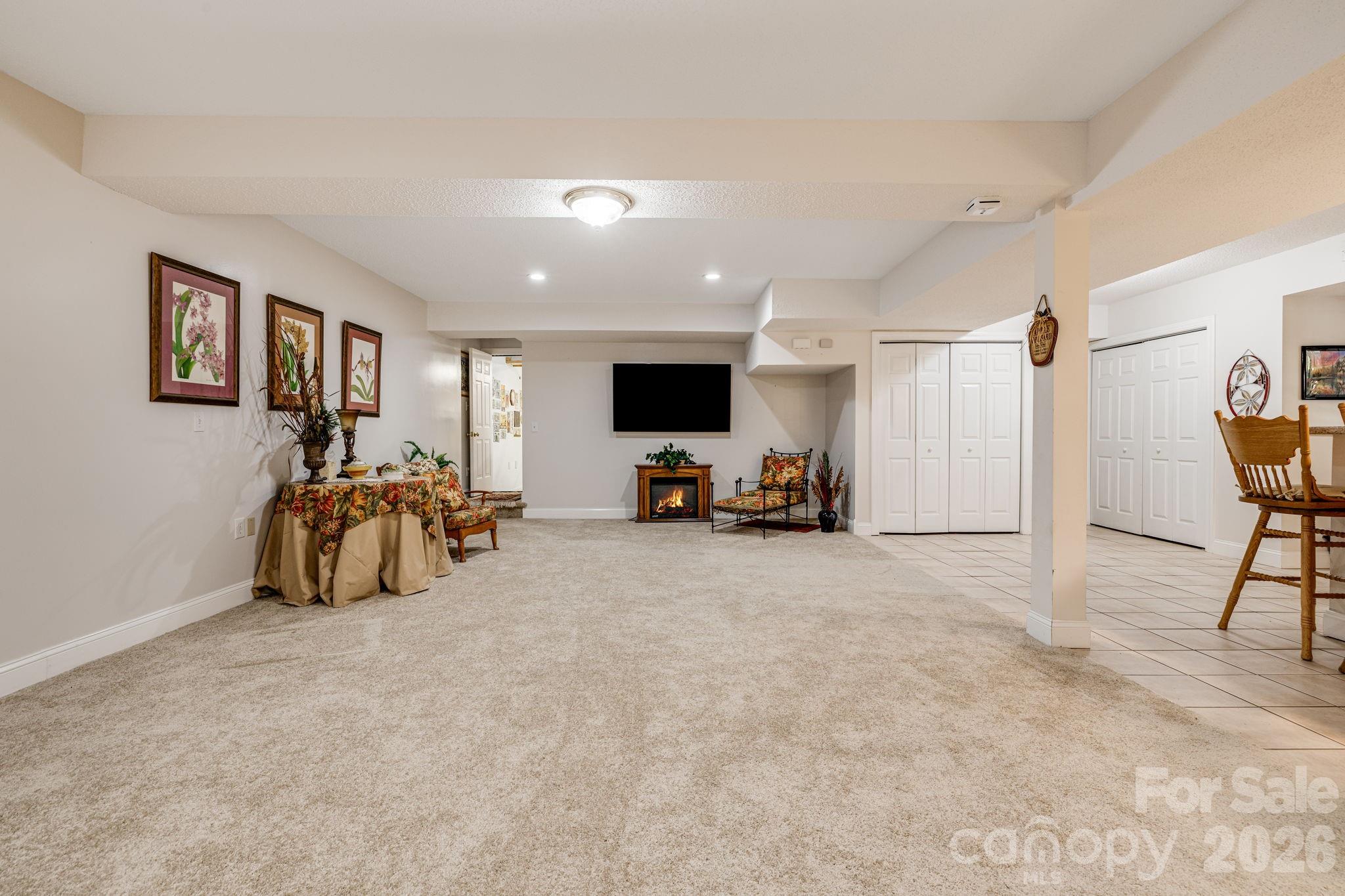 350 Old Sunset Hill Road Hendersonville, NC 28792 - Photo 21 of 40 a room with furniture and a flat screen tv