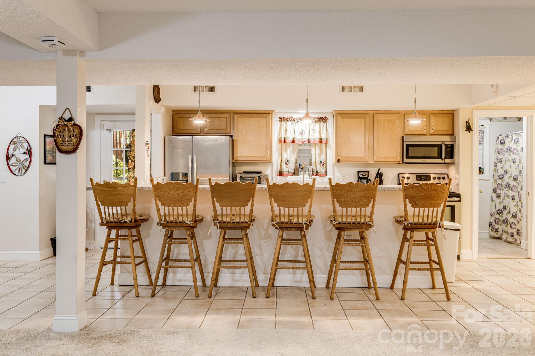350 Old Sunset Hill Road Hendersonville, NC 28792 - Photo 23 of 40 a dining room with furniture and wooden floor