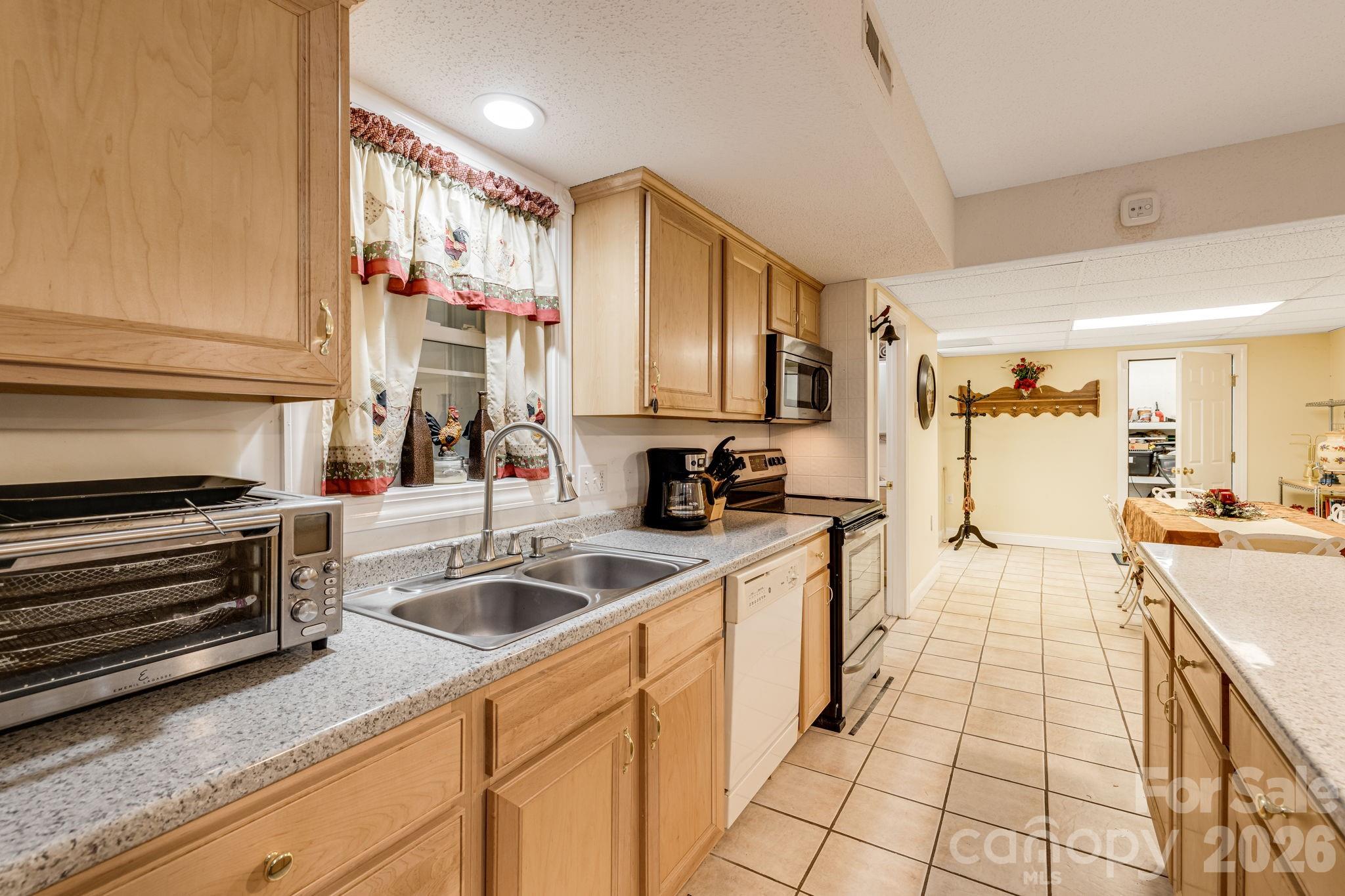 350 Old Sunset Hill Road Hendersonville, NC 28792 - Photo 24 of 40 a kitchen with stainless steel appliances a sink stove and cabinets