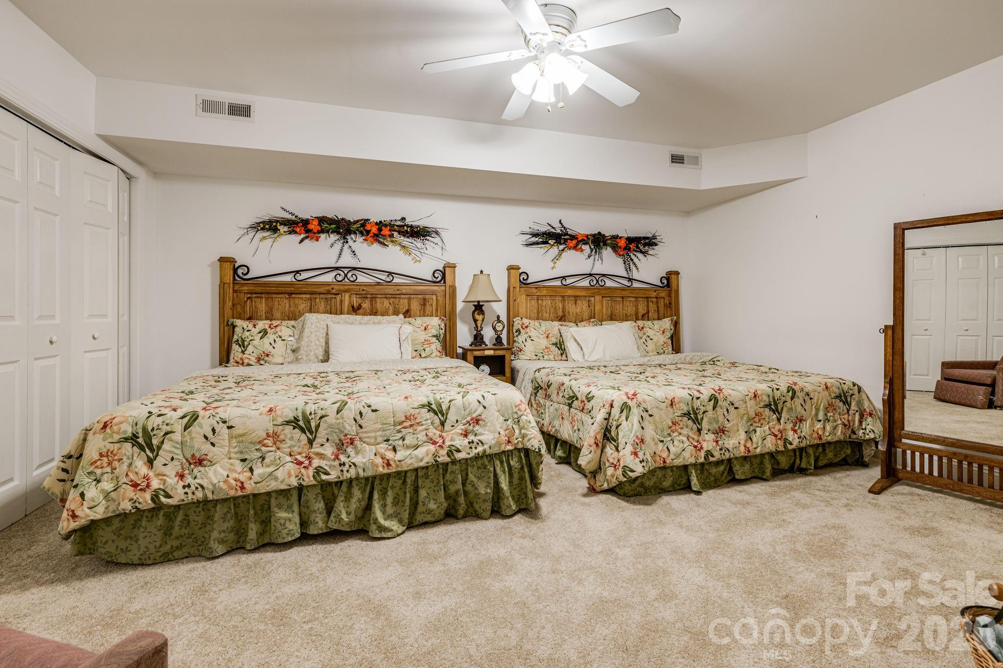 350 Old Sunset Hill Road Hendersonville, NC 28792 - Photo 26 of 40 a bedroom with a bed and a chandelier