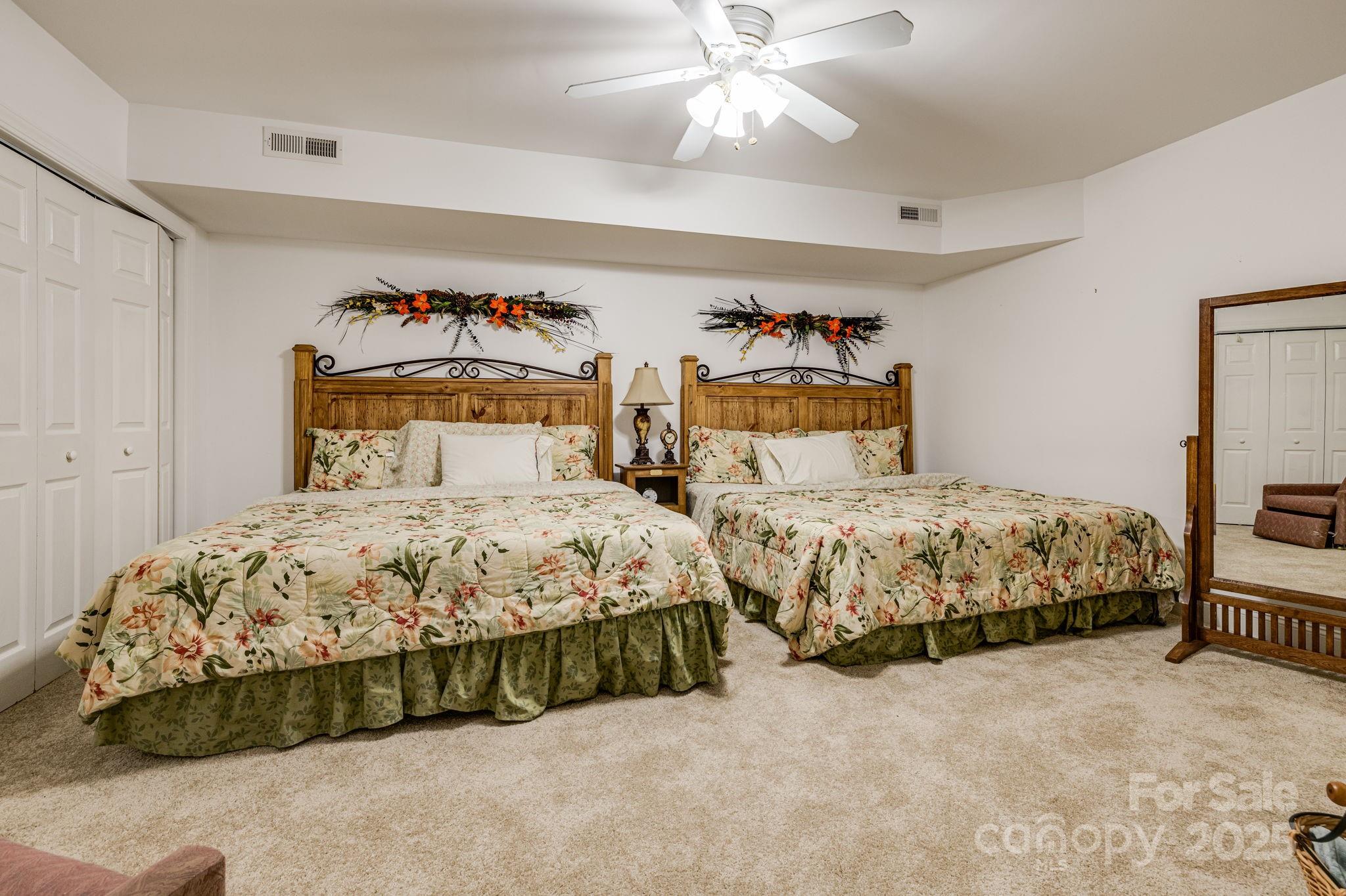 350 Old Sunset Hill Road Hendersonville, NC 28792 - Photo 28 of 40 a bedroom with a bed and a chandelier