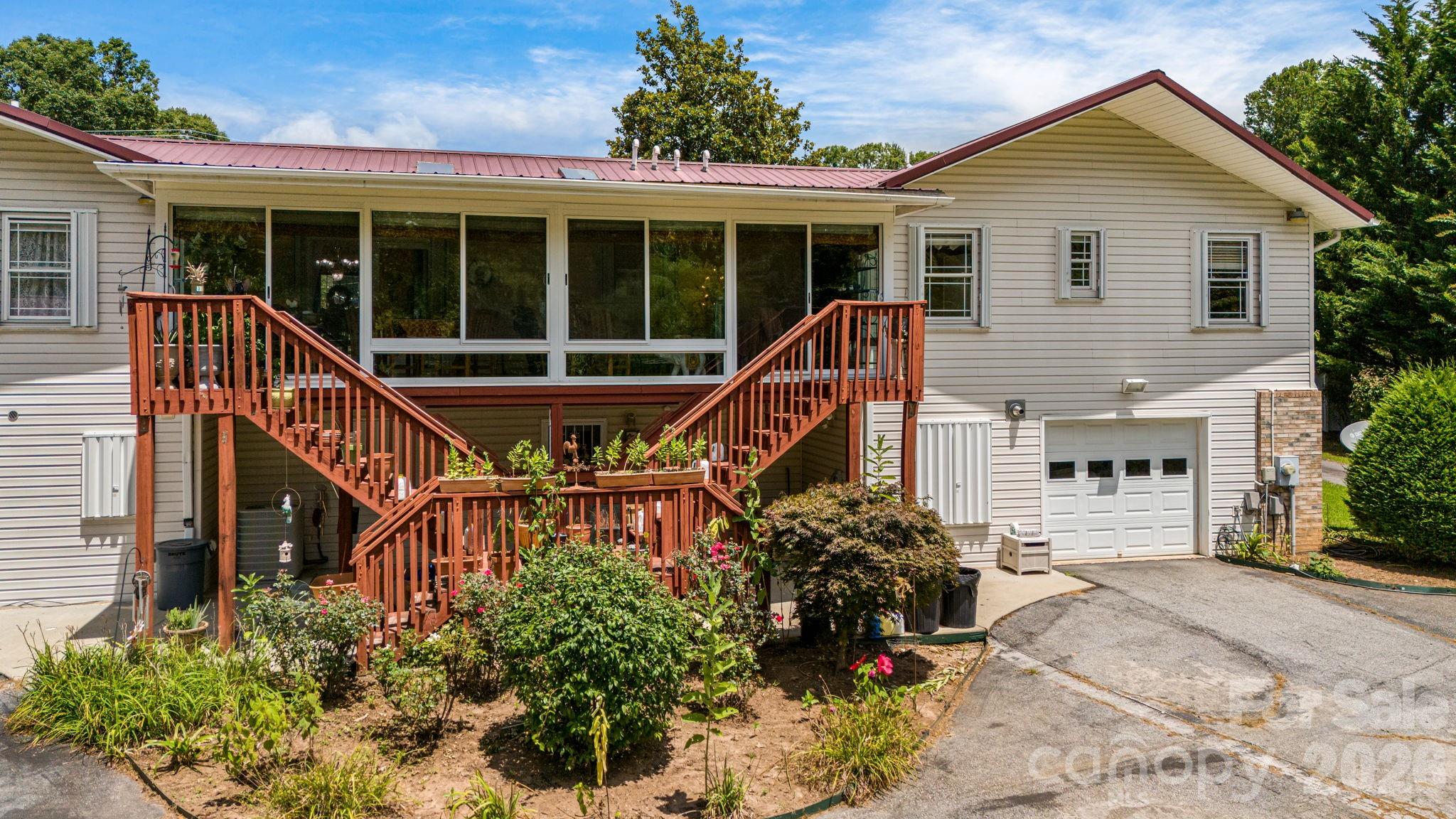 350 Old Sunset Hill Road Hendersonville, NC 28792 - Photo 29 of 40 a view of a house with sitting area and garden